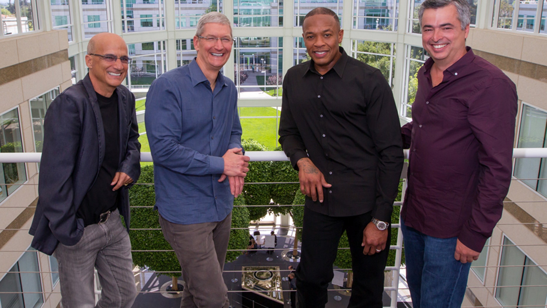 In this image provided by Apple, from left to right, music entrepreneur and Beats co-founder Jimmy Iovine, Apple CEO Tim Cook, Beats co-founder Dr. Dre, and Apple senior vice president Eddy Cue pose together at Apple headquarters in Cupertino, Calif., Wednesday, May 28, 2014. Apple is striking a new chord with a $3 billion acquisition of Beats Electronics, a headphone and music streaming specialist that also brings the swagger of rapper Dr. Dre and recording impresario Jimmy Iovine.