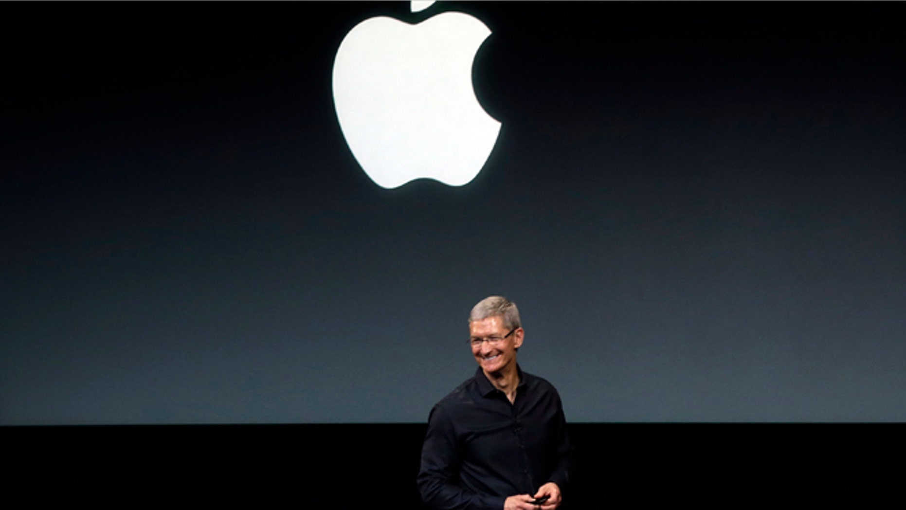 Apple CEO Tim Cook speaks on stage before a new product introduction in Cupertino, Calif., in Sept. 2013.