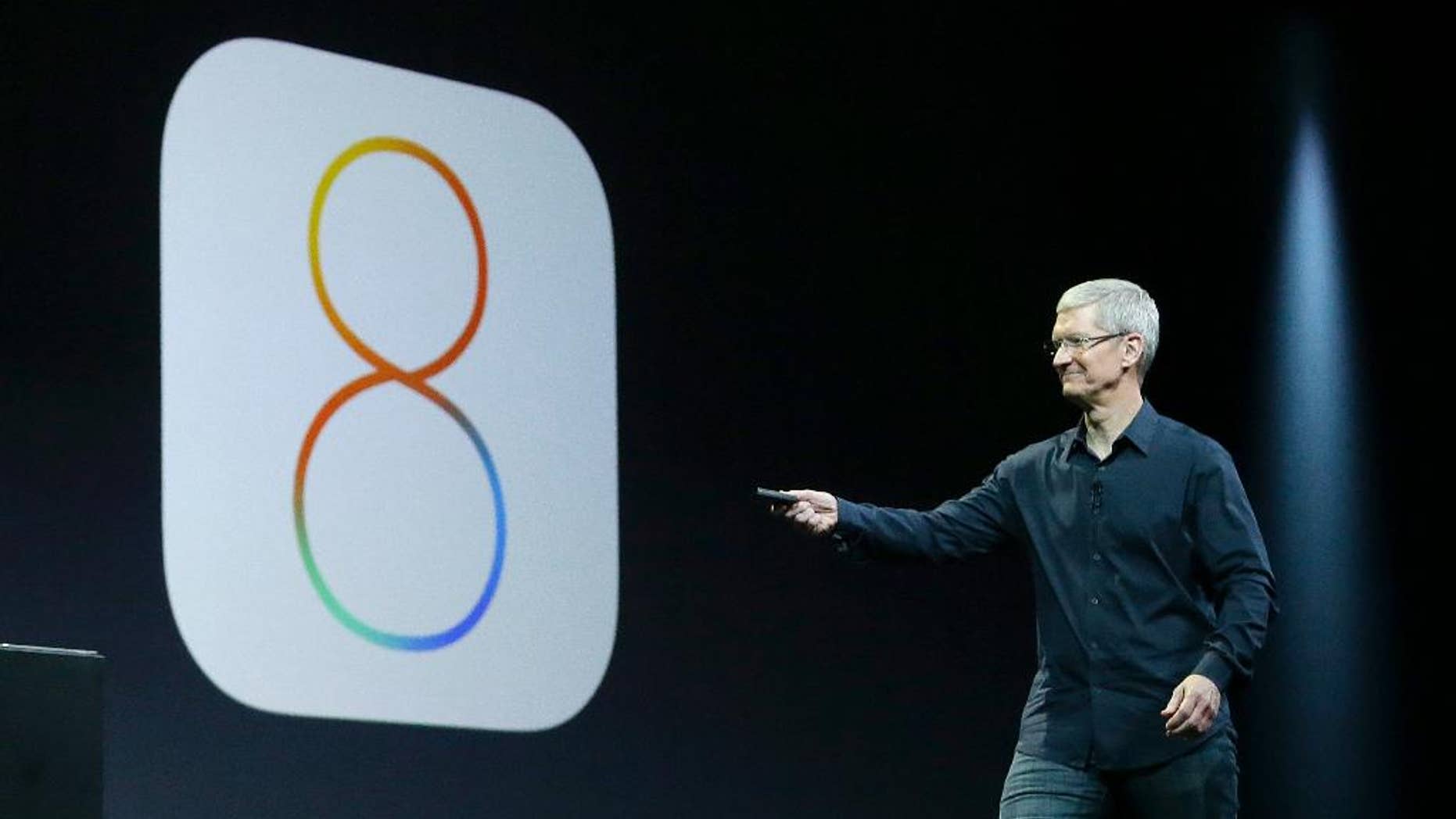 FILE - In this June 2, 2014 photo, Apple CEO Tim Cook speaks about iOS 8 at the Apple Worldwide Developers Conference in San Francisco. Apple has stopped providing an update to its new iOS 8 mobile operating software, following complaints by some users who said Wednesday, Sept. 24, 2014, that the update interferes with their ability to make phone calls. (AP Photo/Jeff Chiu, File)