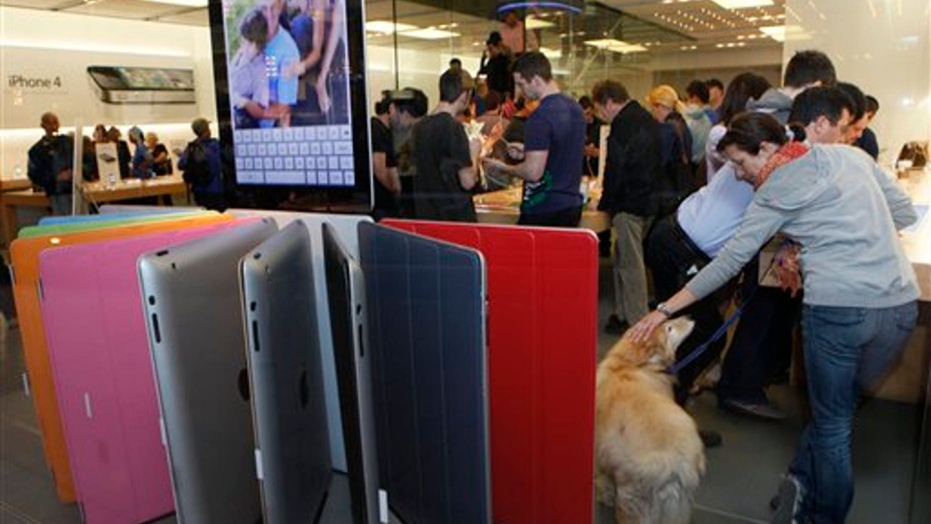March 11: Shoppers buy the new iPad 2 at The Grove Apple store in Los Angeles. (AP)