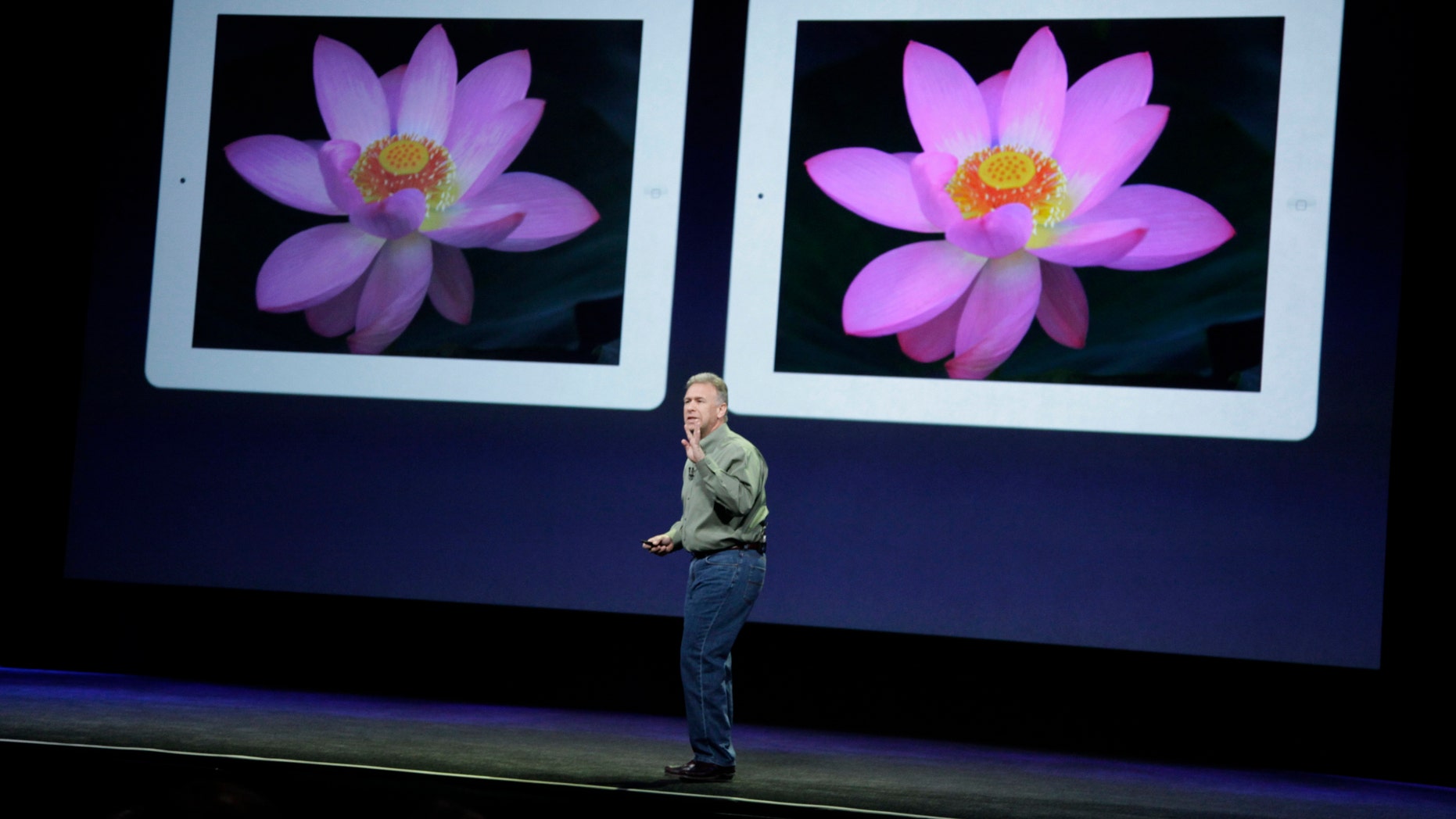March 7, 2012: Apple's senior vice president of Worldwide Marketing Phil Schiller stands in front of an old iPad, left, and new iPad, right, during an Apple event in San Francisco.