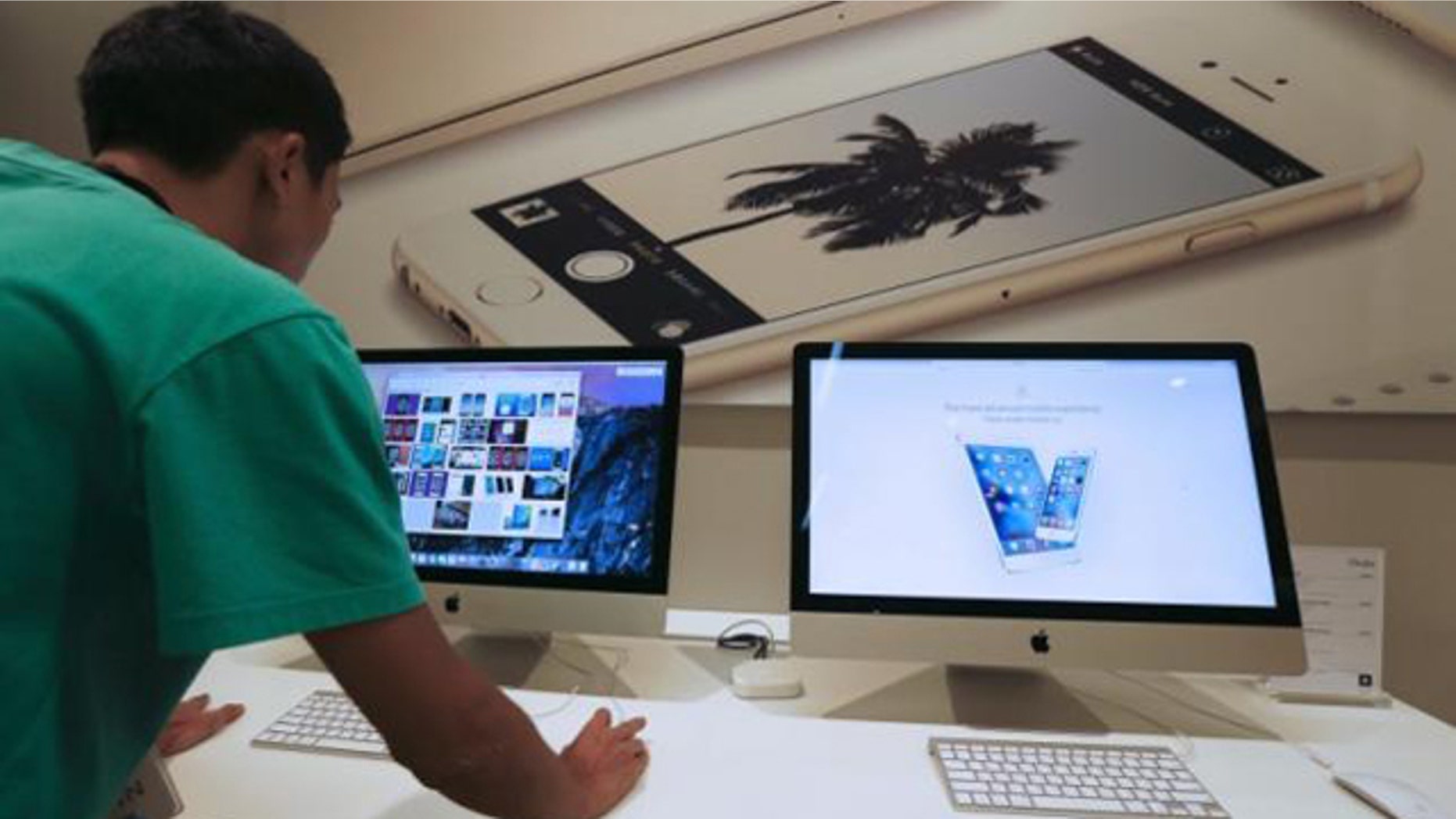 Sept. 18, 2015: A sales assistant shows features of iOS 9 on an Apple iMac at an Apple reseller shop in Bangkok. (Reuters/Chaiwat Subprasom)