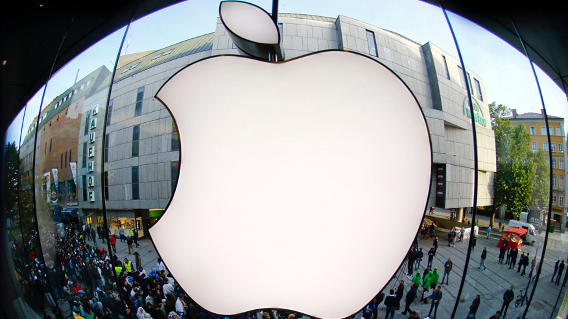 Customers gather outside an Apple store before the release of iPhone 5 in Munich early Sept. 21, 2012.