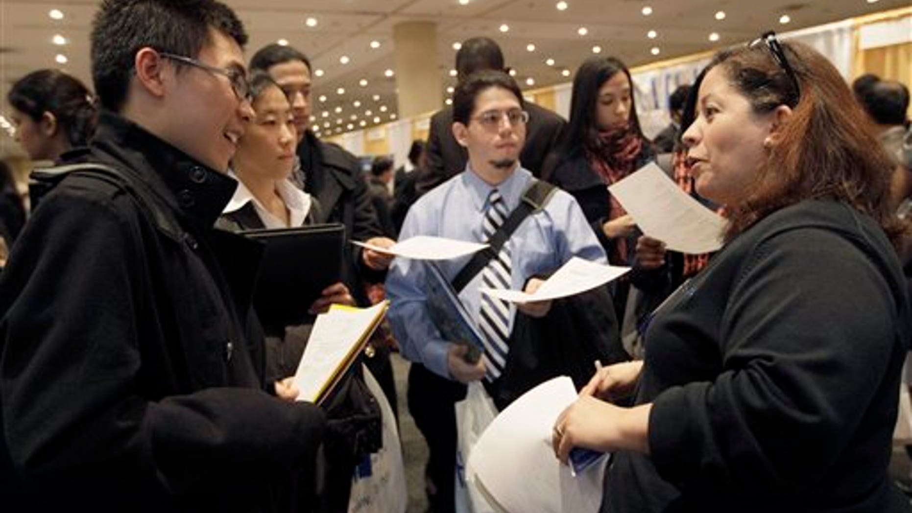 April 8: A recruiter speaks to job applicants during the 23rd annual CUNY Big Apple Job Fair, at the Jacob K. Javits convention center in New York.