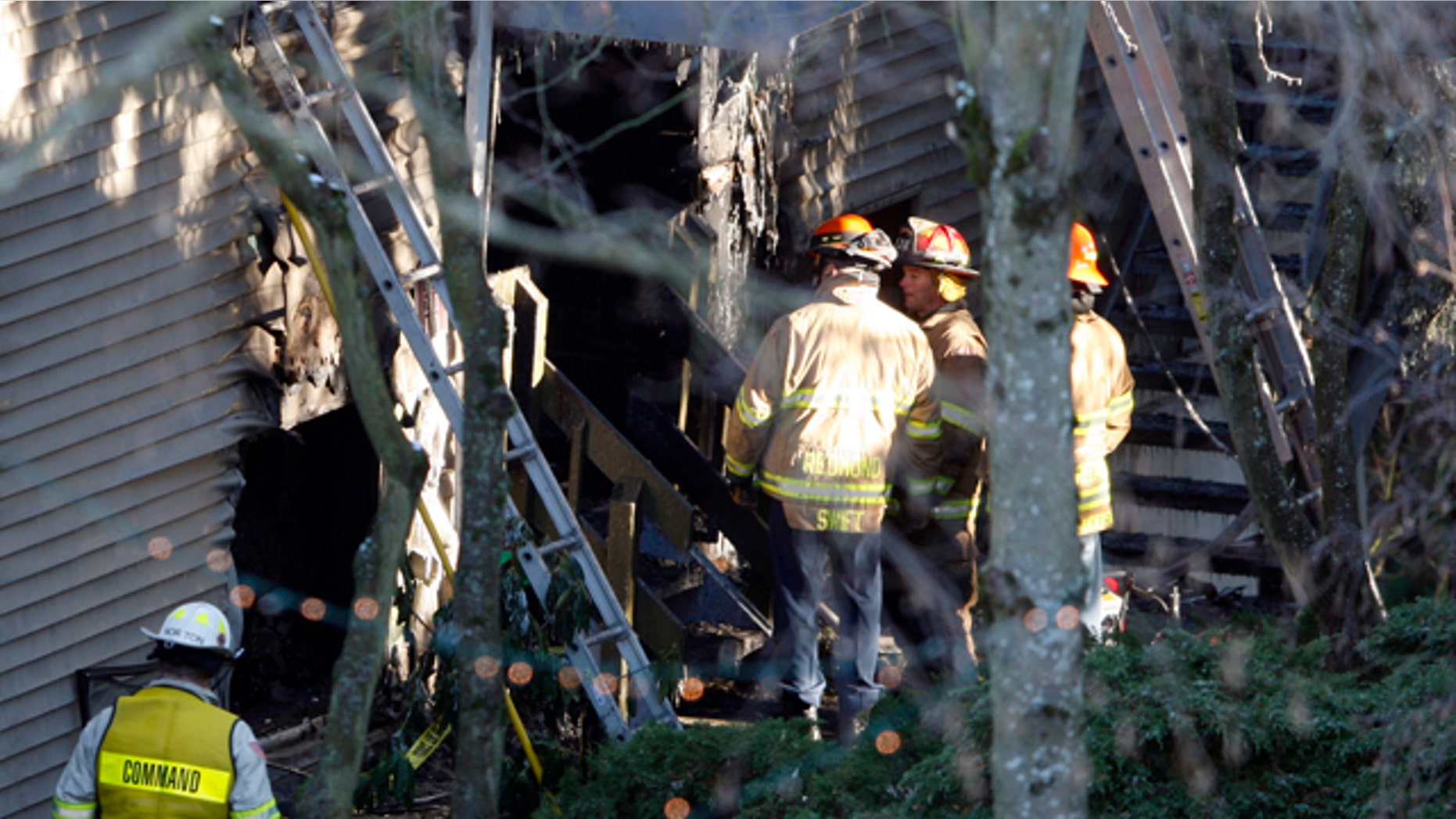 Jan. 1, 2011: Redmond firefighters and investigators insepct the scene of an apartment fire that claimed the lives of five people in Redmond, Wash.