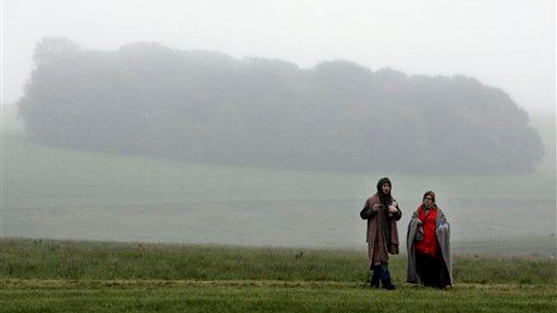 People walk on the fields near Salisbury, the present-day site of a medieval city.