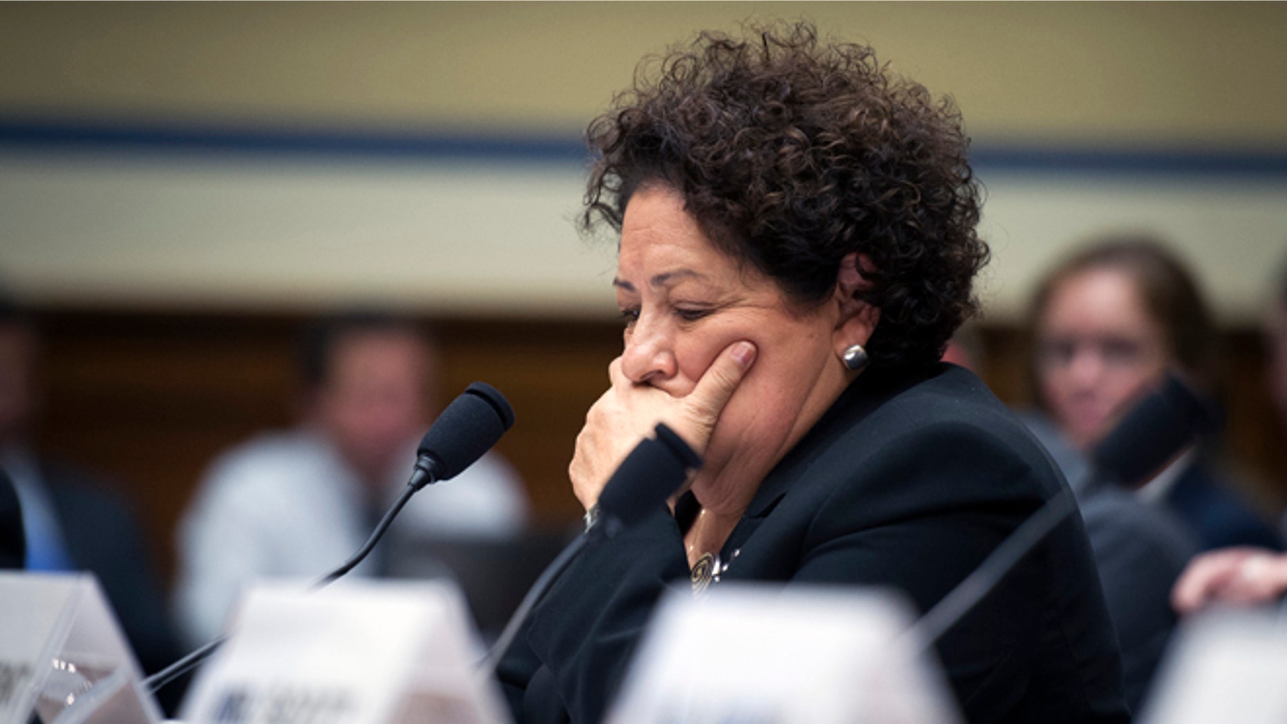 FILE - In this June 16, 2015 file photo, Office of Personnel Management (OPM) Director Katherine Archuleta pauses while testifying on Capitol Hill in Washington. The White House waited roughly four weeks before telling the public that hackers had stolen the personal information of millions of people associated with the federal government, two people directly involved with the investigation tell The Associated Press. In providing a more detailed chronology of the break-in at the U.S. Office of Personnel Management, the two people say the White House decided June 2 to disclose it that week. OPM and the Homeland Security Department publicly confirmed the data thefts on June 4, shortly after the AP broke the story. They spoke on condition of anonymity because parts of the case and techniques being used are classified. (AP Photo/Cliff Owen)