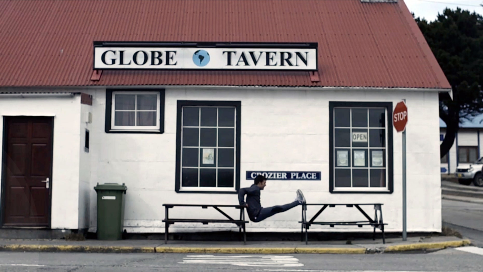 In this frame grab from a TV advertisement released by Argentine Presidential Office, an Argentine Olympic field hockey player Fernando Zylberberg exercises in front of the Globe Tavern in Stanley, Falkland Islands.
