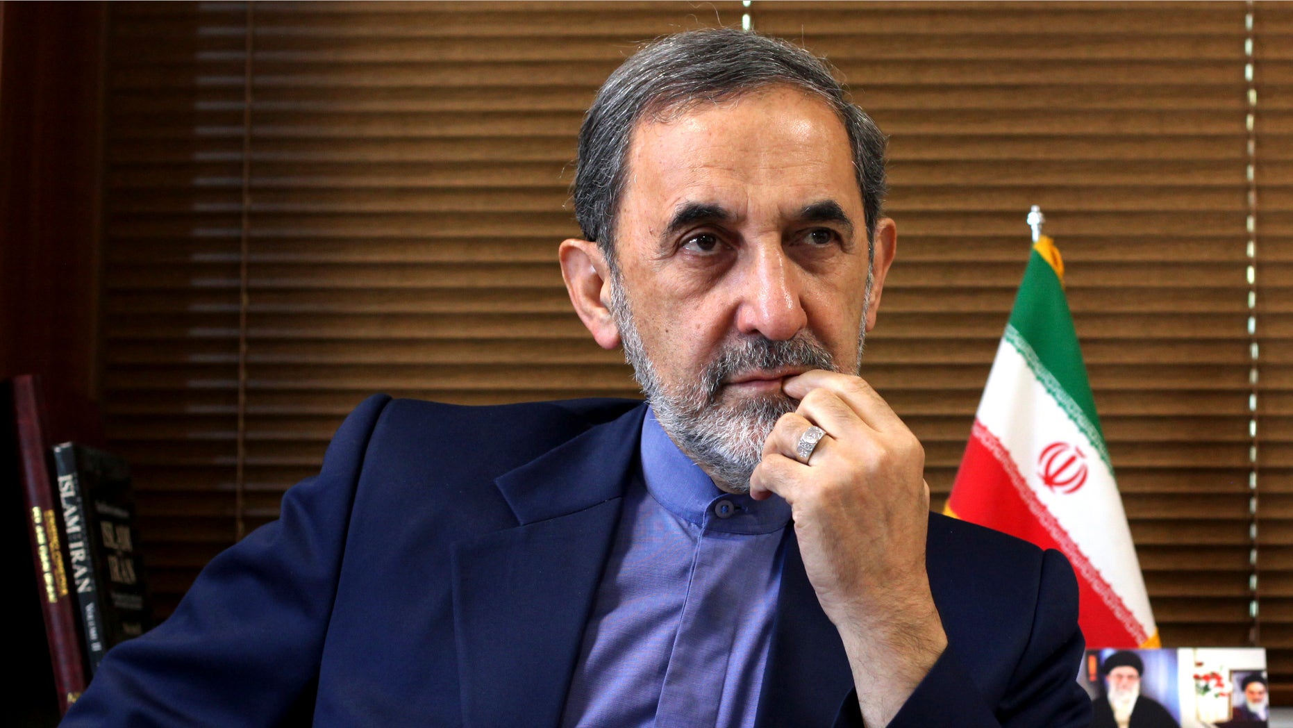 FILE - In this Sunday, Aug. 18, 2013, file photo, Ali Akbar Velayati, a top adviser to Iran's supreme leader Ayatollah Ali Khamenei, gives an interview to The Associated Press at his office, in Tehran, Iran. Velayati accused of masterminding Argentina's worst terrorist attack said Monday, May 18, 2015, that he is innocent and dismissed the accusations against him as baseless. The 1994 bombing of the AMIA Jewish community center that killed 85 people remains unsolved. Former Iranian officials have been on an Interpol capture list for years, but Argentine prosecutors have never been able to question them, and Iran has long denied any role in the bombing. (AP Photo/Ebrahim Noroozi, File)