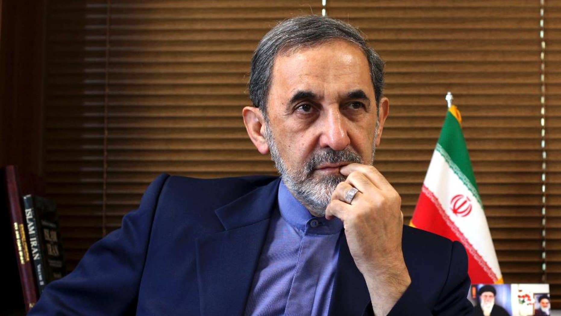 FILE - In this Sunday, Aug. 18, 2013, file photo, Ali Akbar Velayati, a top adviser to Iran's supreme leader Ayatollah Ali Khamenei, gives an interview to The Associated Press at his office, in Tehran, Iran. Velayati accused of masterminding Argentina's worst terrorist attack said Monday, May 18, 2015, that he is innocent and dismissed the accusations against him as baseless. The 1994 bombing of the AMIA Jewish community center that killed 85 people remains unsolved. Former Iranian officials have been on an Interpol capture list for years, but Argentine prosecutors have never been able to question them, and Iran has long denied any role in the bombing. (AP Photo/Ebrahim Noroozi, File)