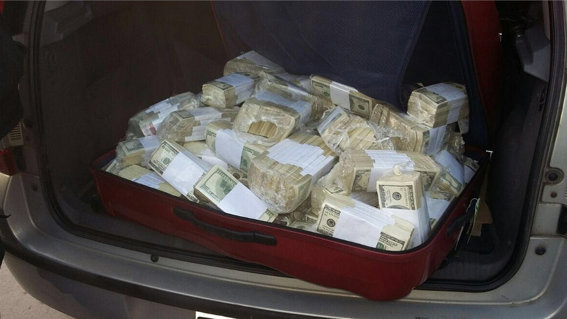 BEST QUALITY AVAILABLE - In this photo released by the Buenos Aires Province Security Ministry, wads of cash sit in the back of a vehicle shortly after former Public Works Secretary Jose Lopez was caught by police hiding millions at a monastery in the outskirts of Buenos Aires, Argentina, Tuesday, June 14, 2016. Lopez, an official in the government of former President Cristina Fernandez was arrested while trying to hide millions in cash and jewels. (Buenos Aires Province Security Ministry via AP)