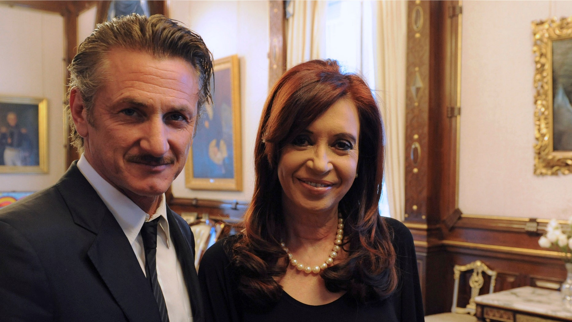 In this picture released by Argentina's Presidency, President Cristina Fernandez poses with actor Sean Penn at government palace in Buenos Aires, Argentina, Monday Feb. 13, 2012. Penn, who is taking Argentina's side in the Falkland Islands dispute, urged Britain to join U.N.-sponsored talks over what he called "the Malvinas Islands of Argentina." (AP Photo/Argentina's Presidency)