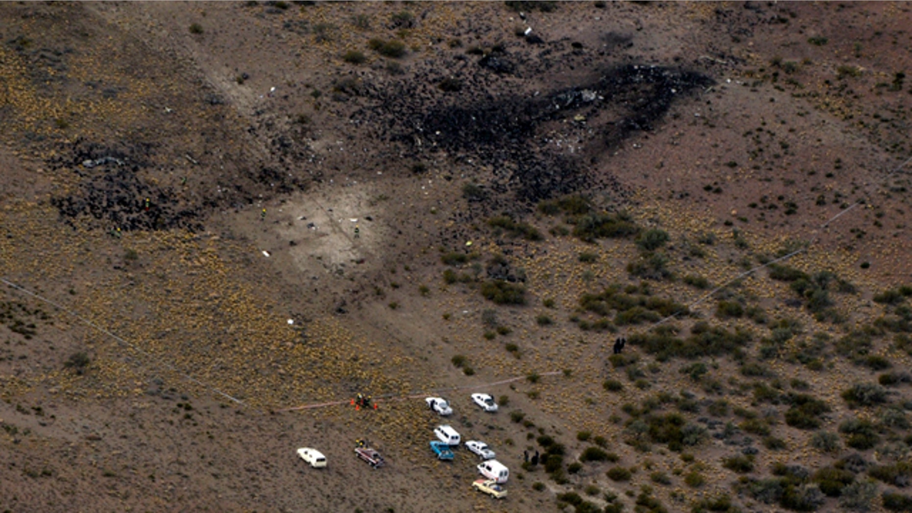 May 19: Firefighters inspect the debris of a plane that crashed and exploded in Argentina's southern Patagonia region killing all 22 on board and disintegrating in the air.