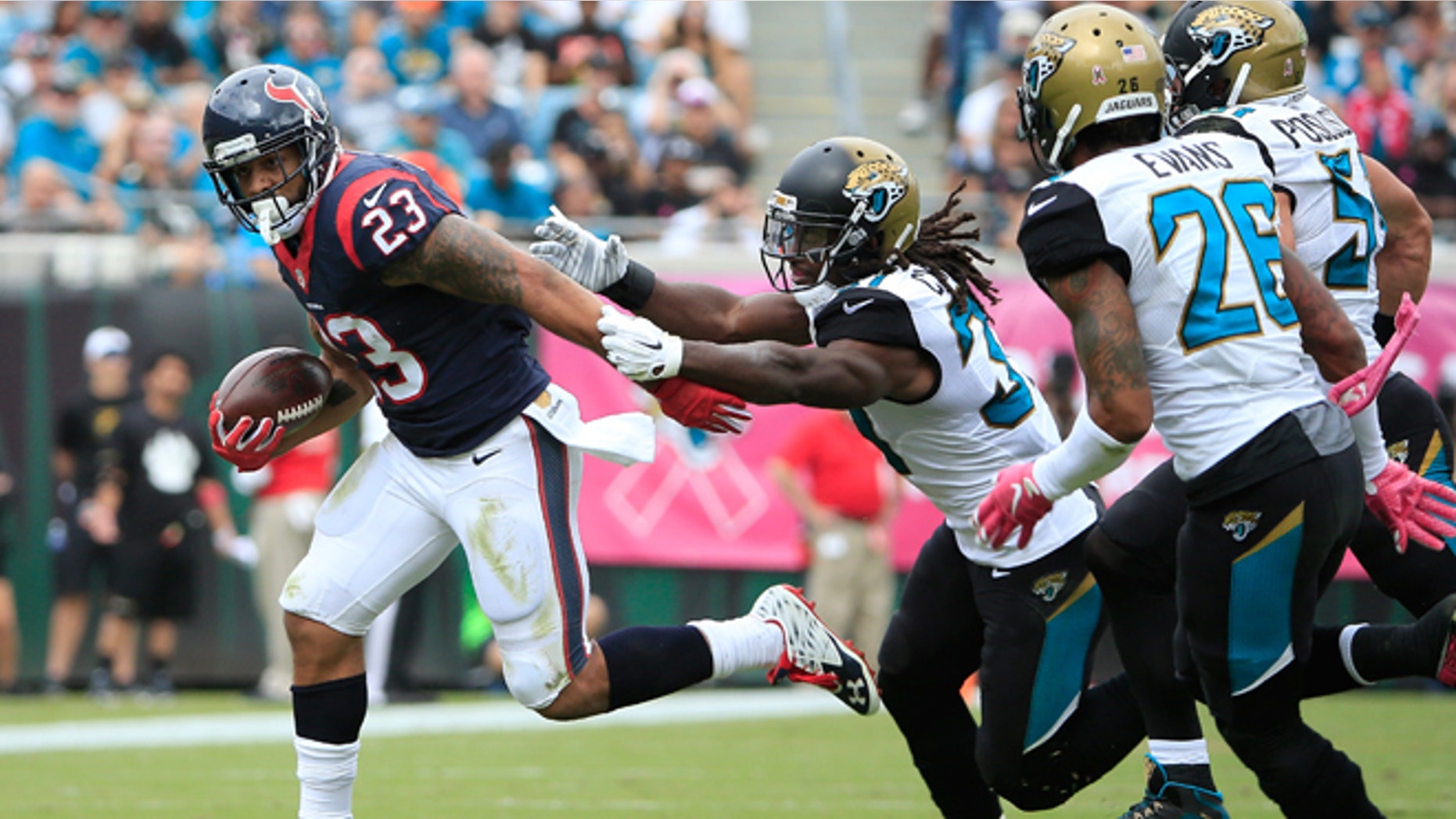 Arian Foster of the Houston Texans rushes against Davon House of the Jacksonville Jaguars on Oct. 18, 2015.
