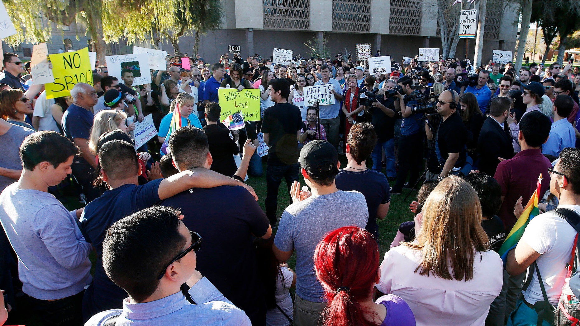 Nearly 250 gay rights supporters protest SB1062 at the Arizona Capitol, Friday, Feb. 21, 2014, in Phoenix.