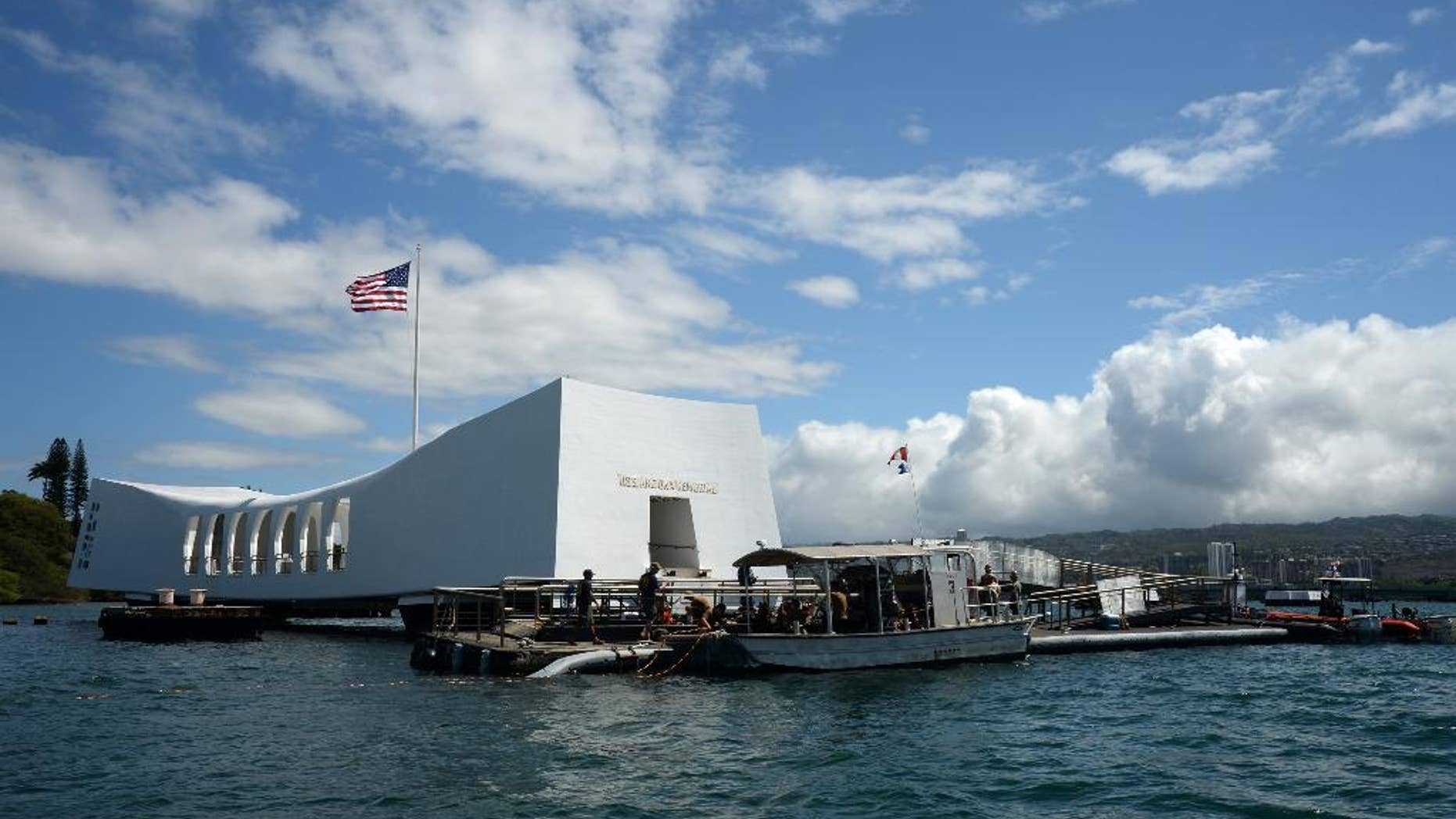 In this Wednesday, June 3, 2015, photo provided by the U.S. Navy, sailors work to repair the floating dock next to the USS Arizona Memorial in Pearl Harbor, Hawaii. Repairs to the damaged dock have been taking longer than expected, which will delay the reopening of the Pearl Harbor landmark at least a day, the navy and National Park Service said Wednesday. (Mass Communication Specialist 2nd Class Laurie Dexter/U.S. Navy via AP)