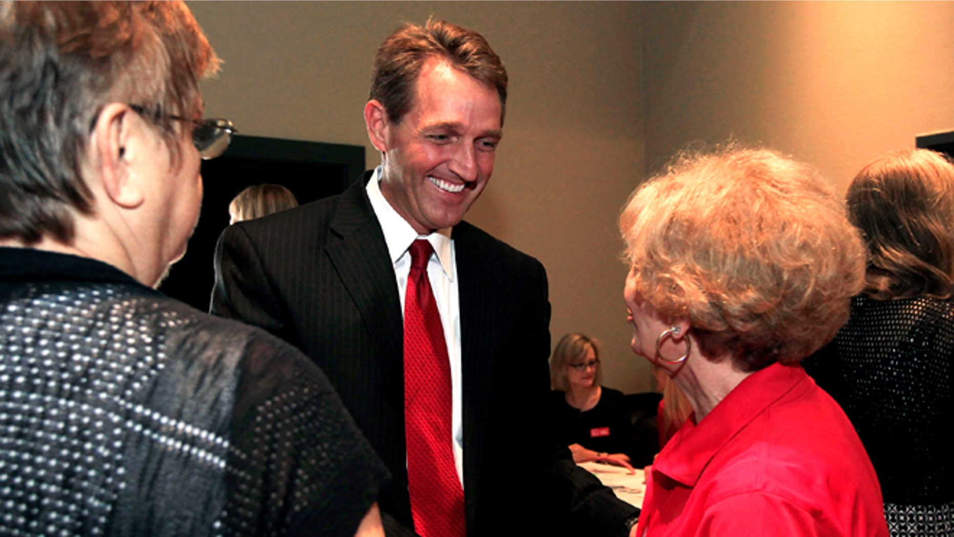 FILE: Aug. 14, 2012: Arizona Republican Senate candidate Rep. Jeff Flake, middle, meets with the Ahwatukee Republican Women group at a candidates forum in Phoenix.