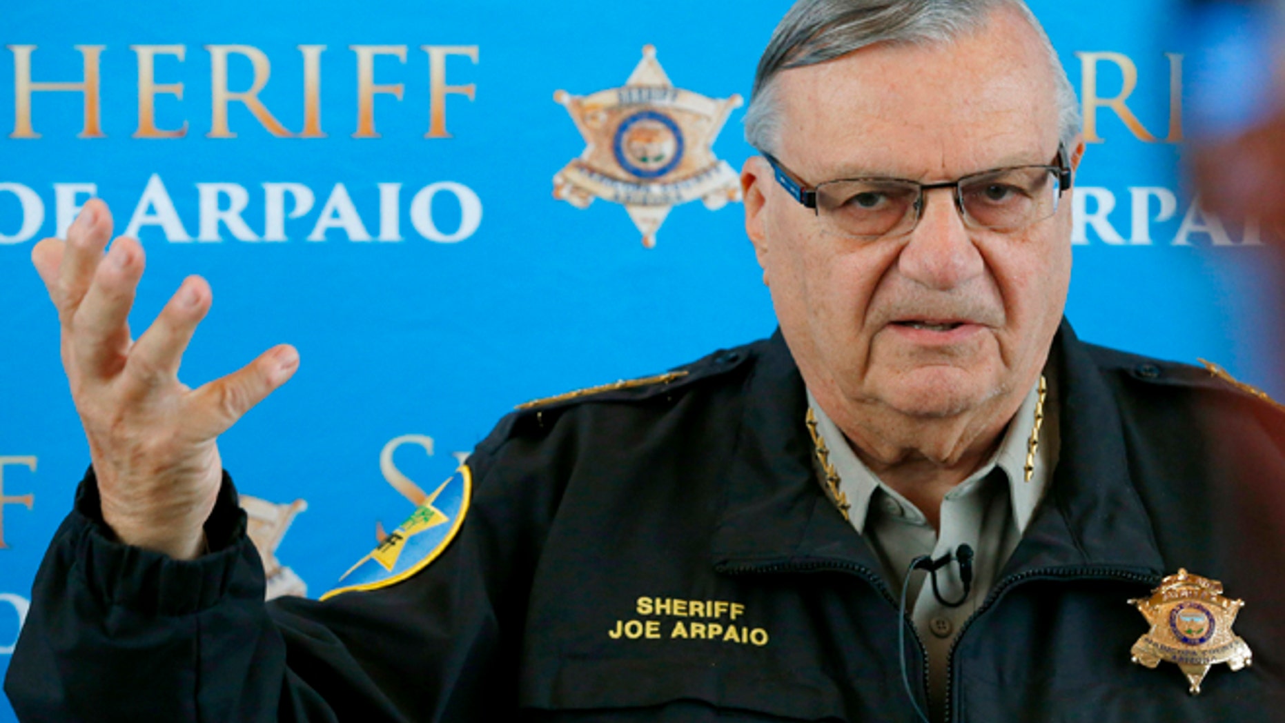 FILE - In this Dec. 18, 2013 file photo, Maricopa County Sheriff Joe Arpaio announces dozens of arrests in a prostitution sting during a news conference at Maricopa County Sheriff's Office Headquarters, in Phoenix. Arpaio and his top aide Chief Deputy Jerry Sheridan are required to appear before a federal judge who believes the two have mischaracterized and trivialized the judge's key findings in a racial-profiling decision issued in 2013 against the police agency. The sheriff's office will be required to provide answers Monday, March 24, 2014 to U.S. District Judge Murray Snow about an Oct. 18 training session in which the judge said Sheridan appears to suggest that rank-and-file deputies weren't obliged to make their best efforts to remedy the agency's constitutional violations. (AP Photo/Ross D. Franklin, File)