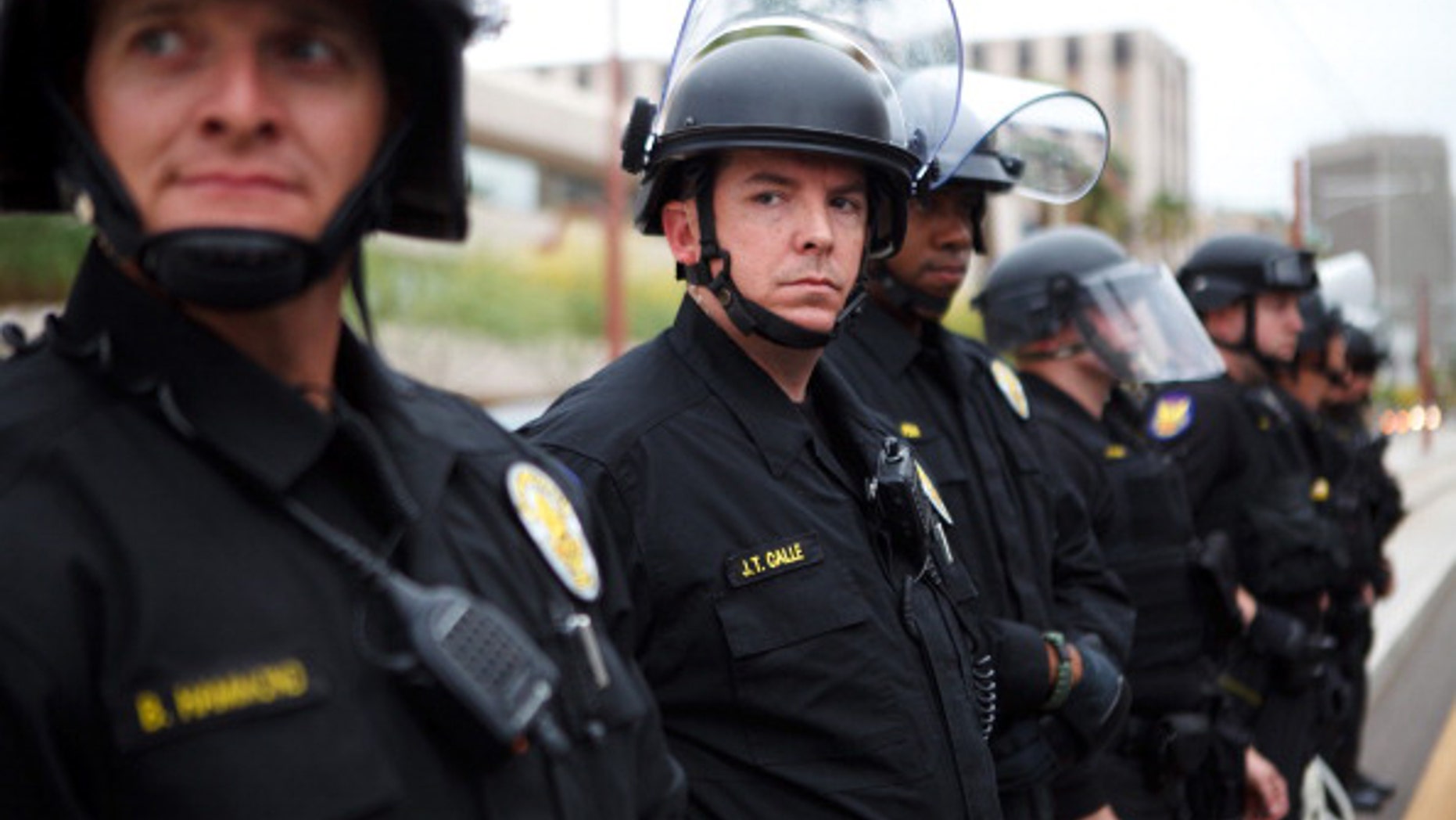 PHOENIX, AZ - APRIL 25: Police officers look on as protester opposed to Arizona's Immigration Law SB 1070 rally April 25, 2012 in Phoenix, Arizona. Immigrant rights advocates held a day of protest in Phoenix, the same day the U.S. Supreme Court heard arguments over Arizona's 2010 immigration enforcement law. (Photo by Jonathan Gibby/Getty Images)