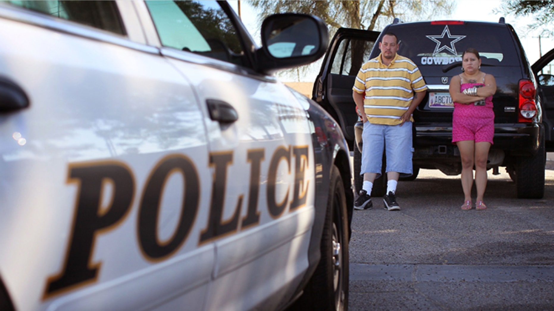 TUCSON, AZ - MAY 29: Javier Smith and his wife Guadalupe Salvador talk with police about problems the are having with Salvador's ex-husband May 29, 2010 in Tucson, Arizona. The Tucson Police Department is currently gearing up to begin training its officers on the implementation of the controversial new immigration law SB1070. Although a Tucson police officer was one of the first to file suit in federal court challenging the new law, most rank and file officers tend to support the legislation while the Arizona Chiefs of Police have criticized it. (Photo by Scott Olson/Getty Images)