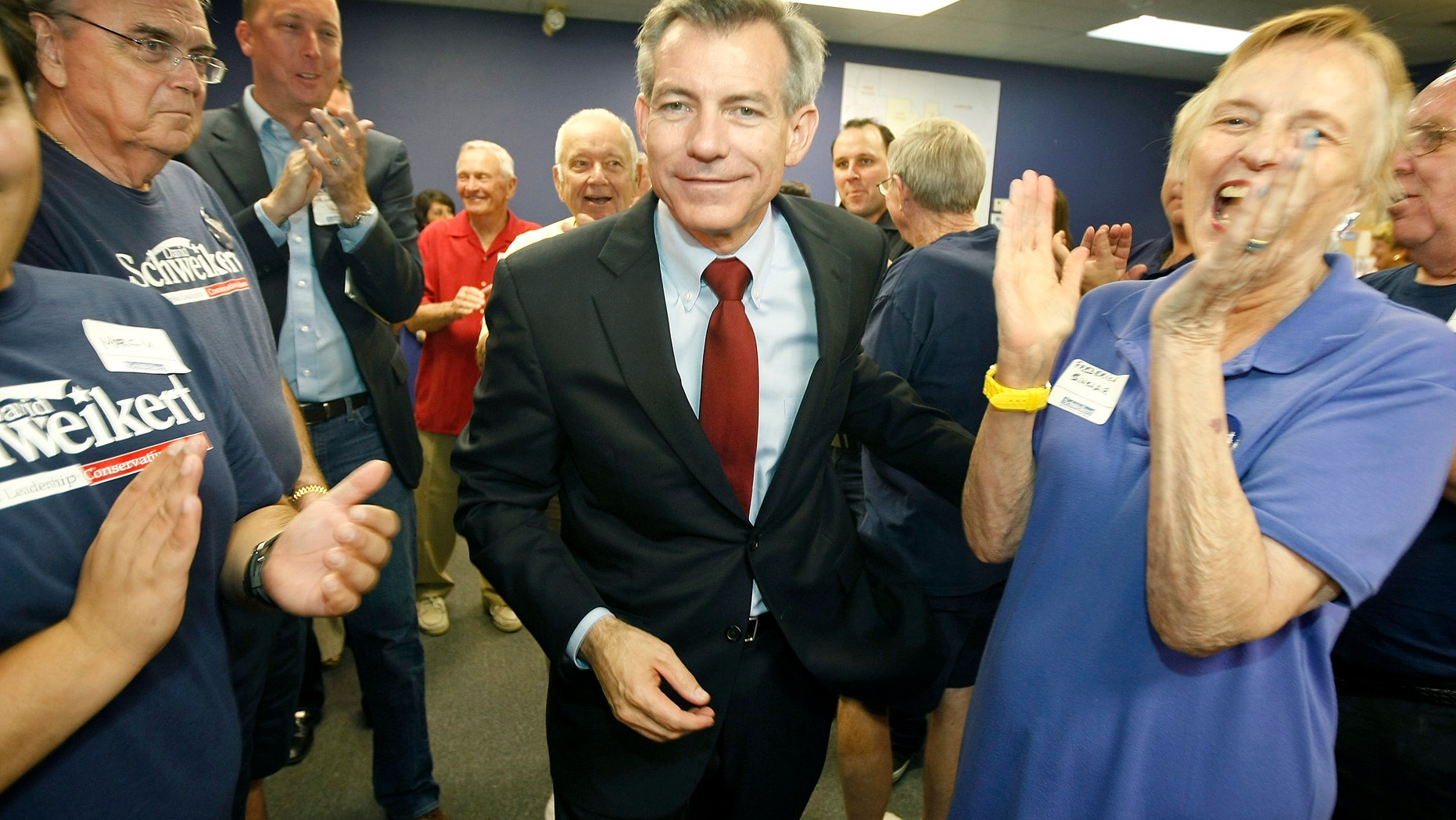Aug. 28, 2012: Congressional District 6 candidate Rep. David Schweikert, R-Arizona, walks through a crowd of applauding supporters at his campaign headquarters in Phoenix after being declared the winner in his election primary over opponent Rep. Ben Quayle.
