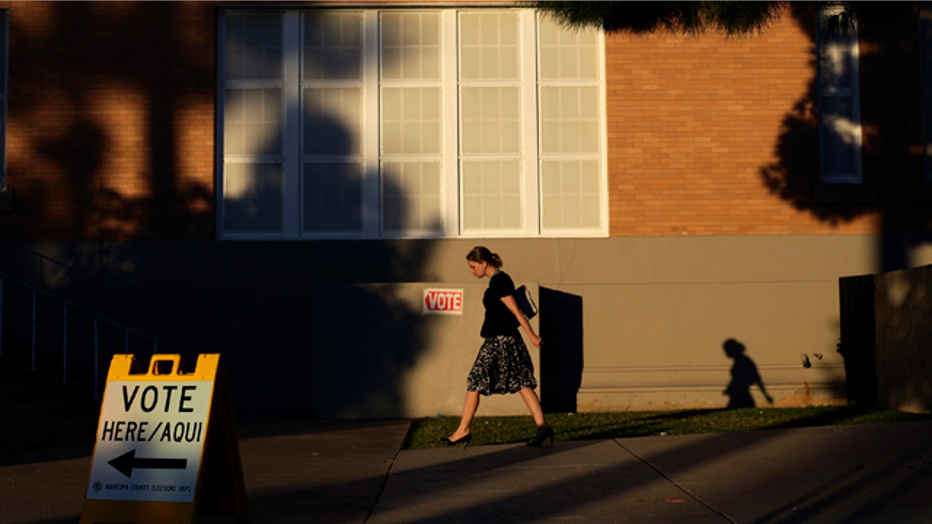 Nov. 6, 2012: A woman walks outside Kenilworth School as she prepares to vote during the U.S. presidential election in Phoenix, Arizona.
