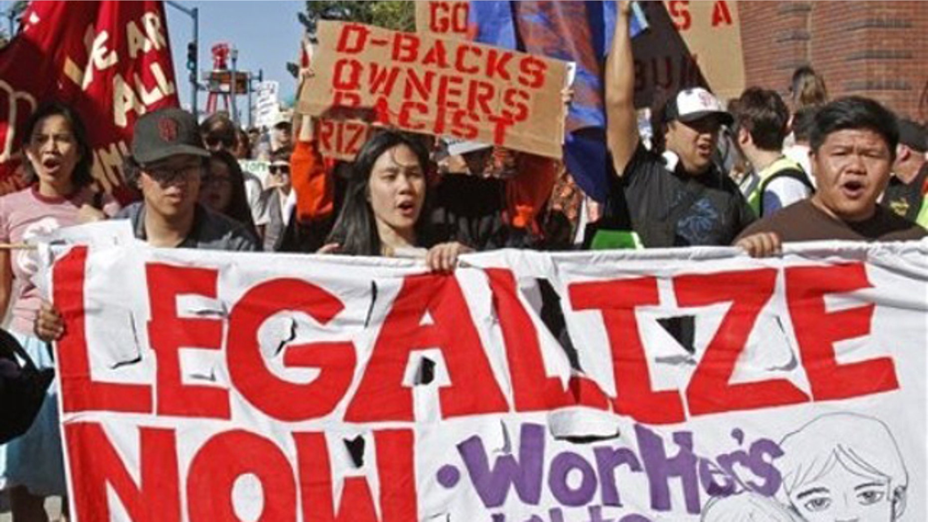 Protestors outside AT&T Park join in the "National Day of Action Against SB1070" by picketing the Arizona Diamondbacks vs. San Francisco Giants baseball game Saturday, May 29, 2010, in San Francisco. The protest was held in support of the Boycott Arizona campaign.(AP)