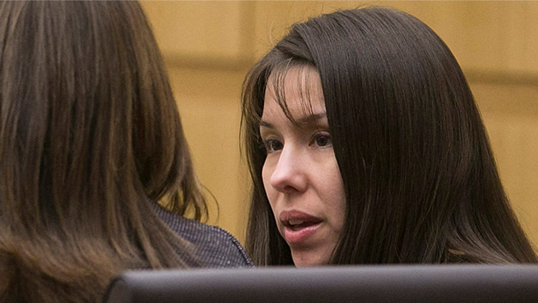 Jan. 2, 2013: Defendant Jodi Arias talks with her defense team during the prosecution's opening statements in the trial of Arias in Maricopa County court in Phoenix. (AP/The Arizona Republic)