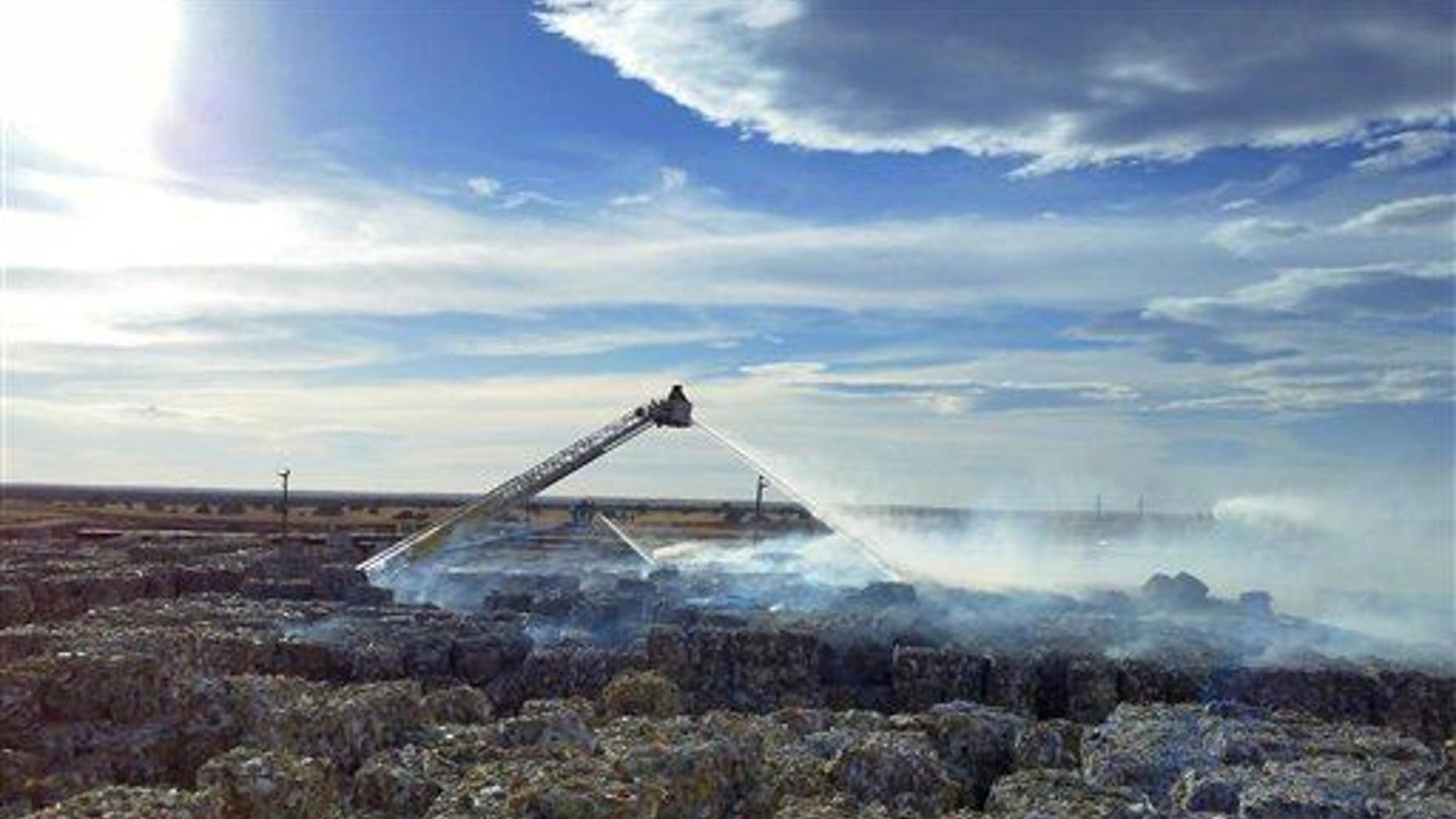 Firefighters in Snowflake, Arizona, douse a recycling fire in this file photo.