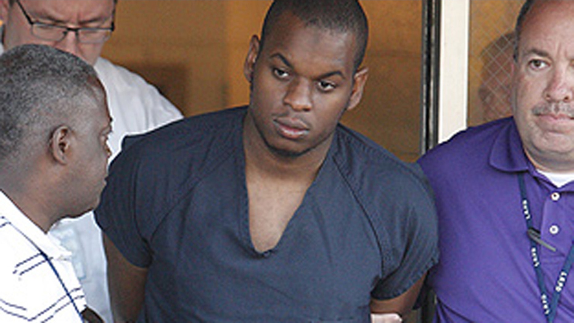 June 1, 2009: Suspected shooter Abdulhakim Mujahid Muhammad is escorted from Little Rock police headquarters after a military recruiting center attack in Arkansas.