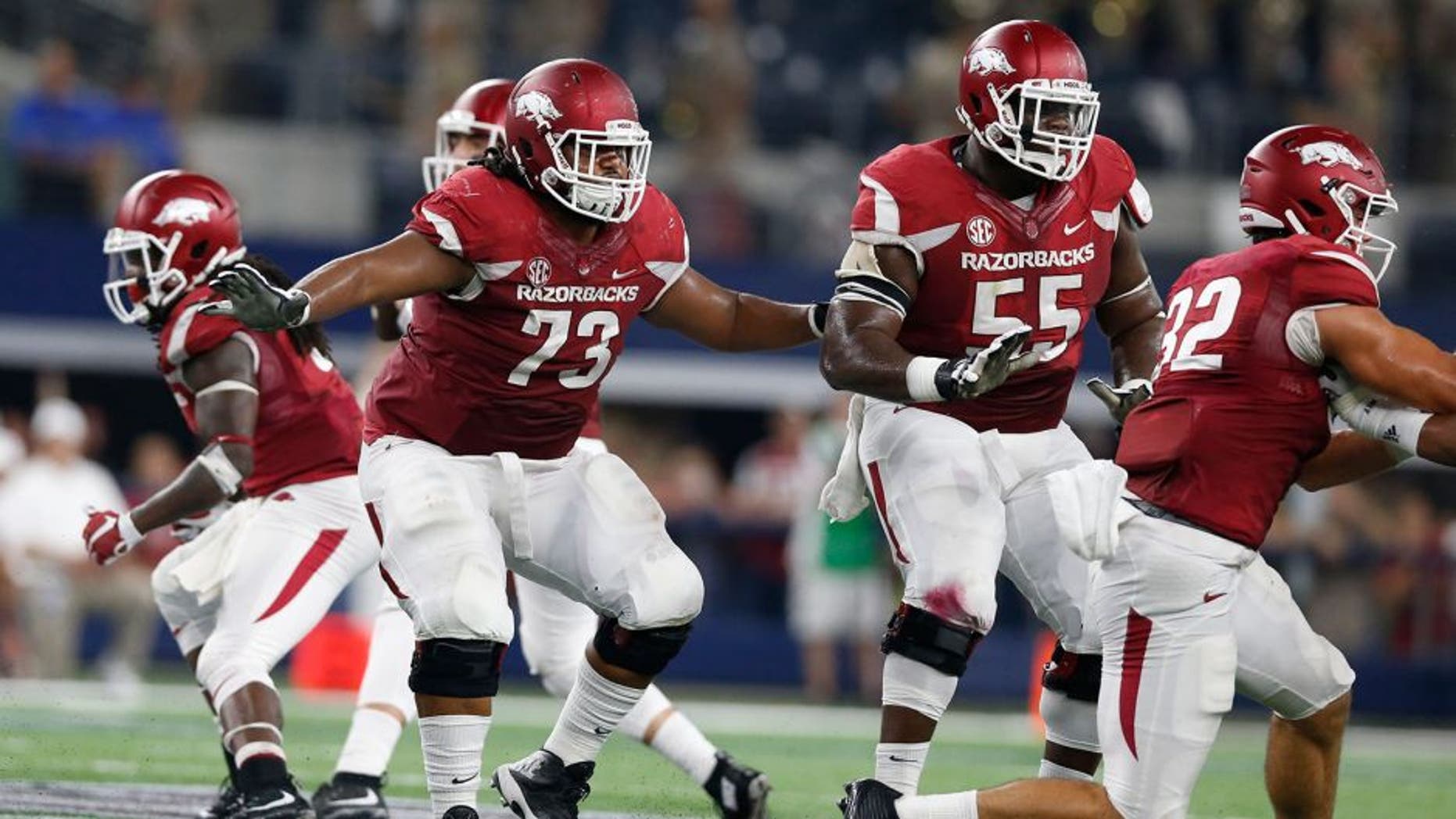 Sep 26, 2015; Arlington, TX, USA; Arkansas Razorbacks guard Sebastian Tretola (73) in action with tackle Jeremiah Levbetter (55) against the Texas A&M Aggies at AT&T Stadium. Mandatory Credit: Matthew Emmons-USA TODAY Sports