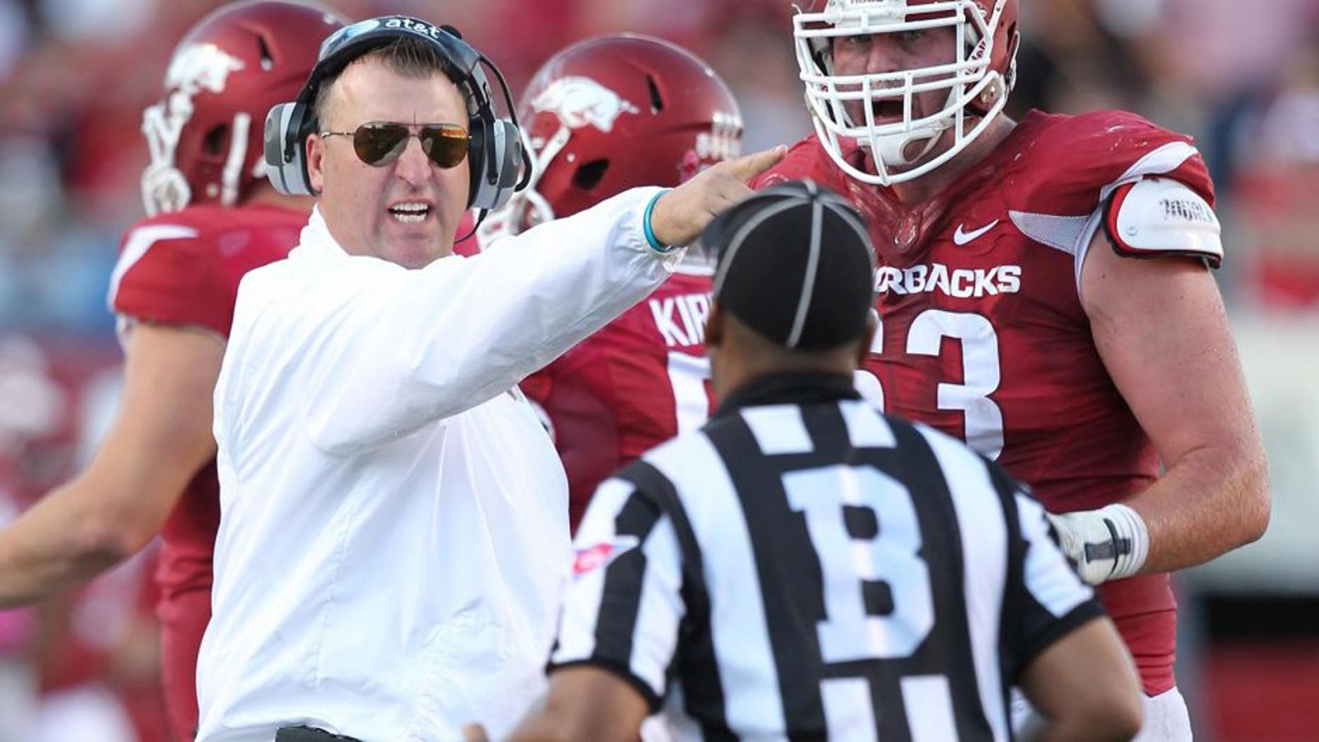 Oct 18, 2014; Little Rock, AR, USA; Arkansas Razorbacks head coach Bret Bielema and offensive tackle Dan Skipper (63) argue a call with an official during the game against the Georgia Bulldogs at War Memorial Stadium. Georgia defeated Arkansas 45-32. Mandatory Credit: Nelson Chenault-USA TODAY Sports