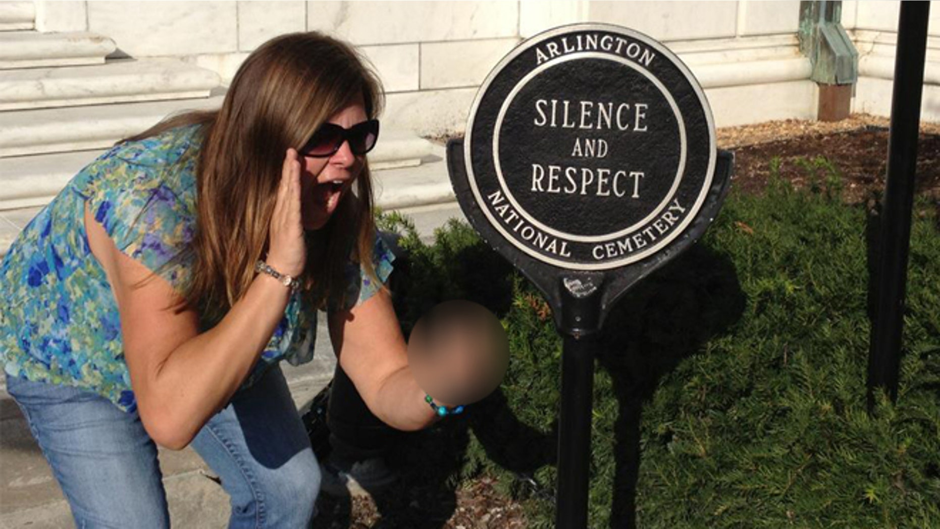 This photo of Lindsey Stone at Arlington National Cemetery generated a national controversy after it was posted to Facebook and went viral, ultimately costing Stone and another person their jobs at a nonprofit.