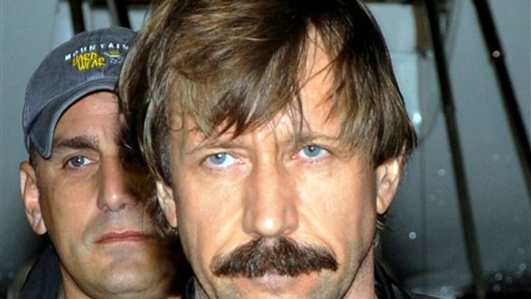 FILE - This Tuesday Nov. 16, 2010 file photo provided by the Drug Enforcement Administration shows Russian arms trafficker Viktor Bout in U.S. custody after being flown from Bangkok to New York.