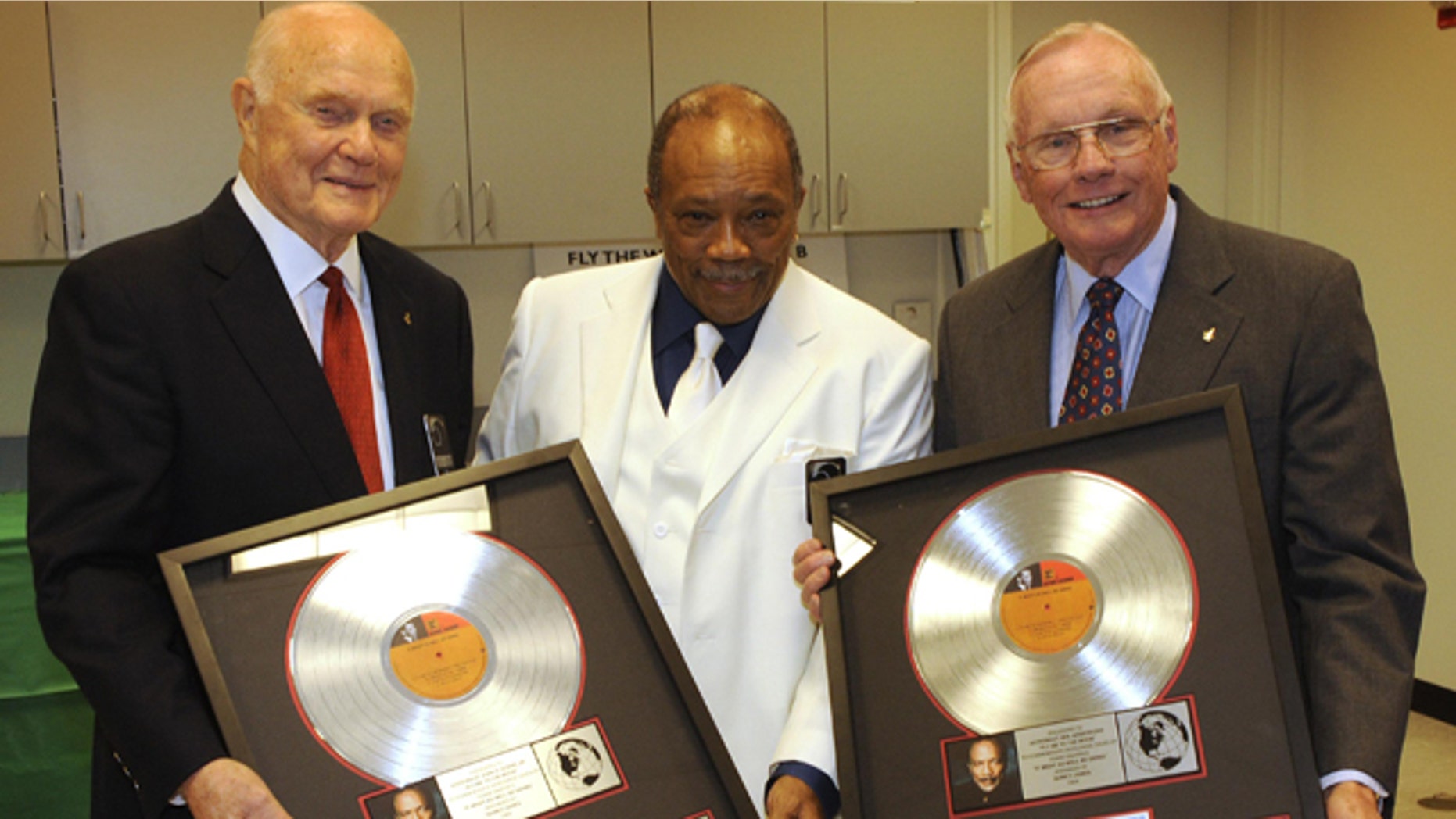 Grammy Award-winning producer Quincy Jones (center) presented a platinum copy of "Fly Me to the Moon" to Senator John Glenn (left) and Apollo 11 Commander Neil Armstrong (right) during NASA's 50th anniversary gala in 2008.
