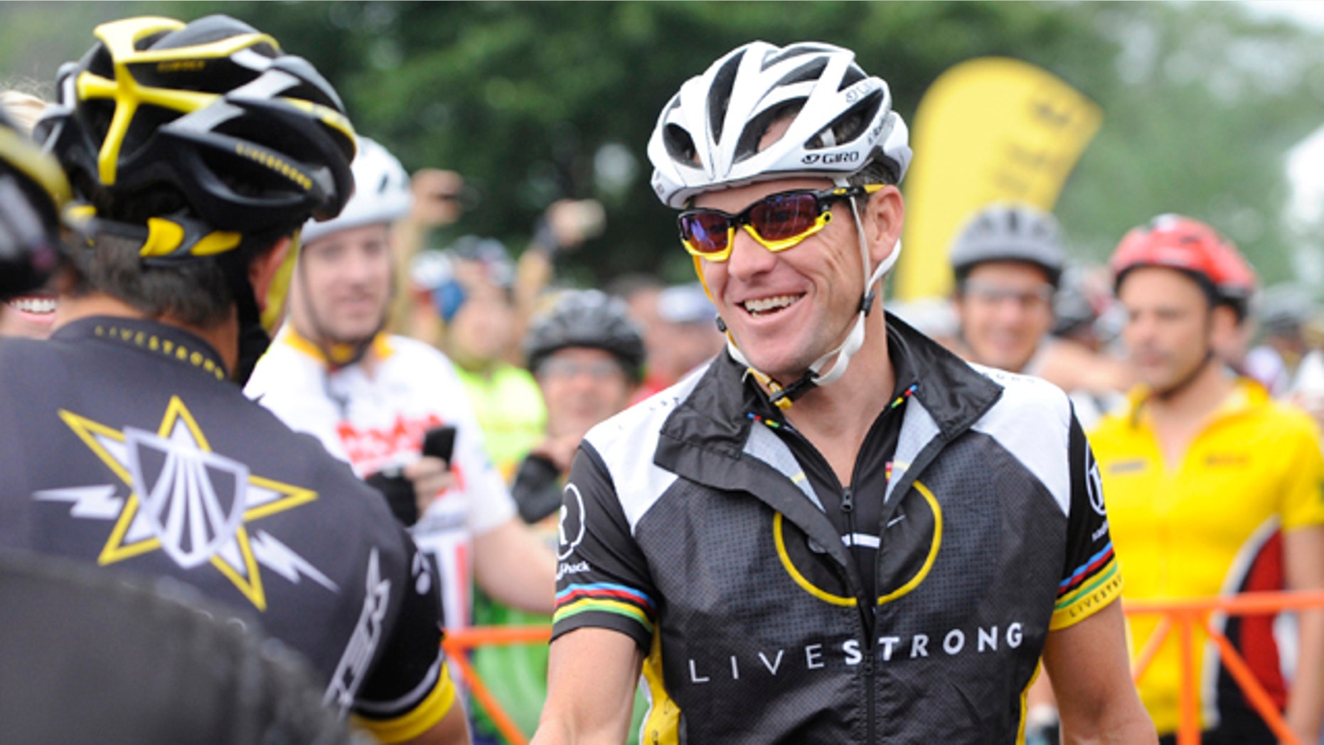 Aug. 22, 2010: This file photo shows Lance Armstrong, center, greeting fellow riders prior to the start of his Livestrong Challenge 10K ride for cancer in Blue Bell, Pa.