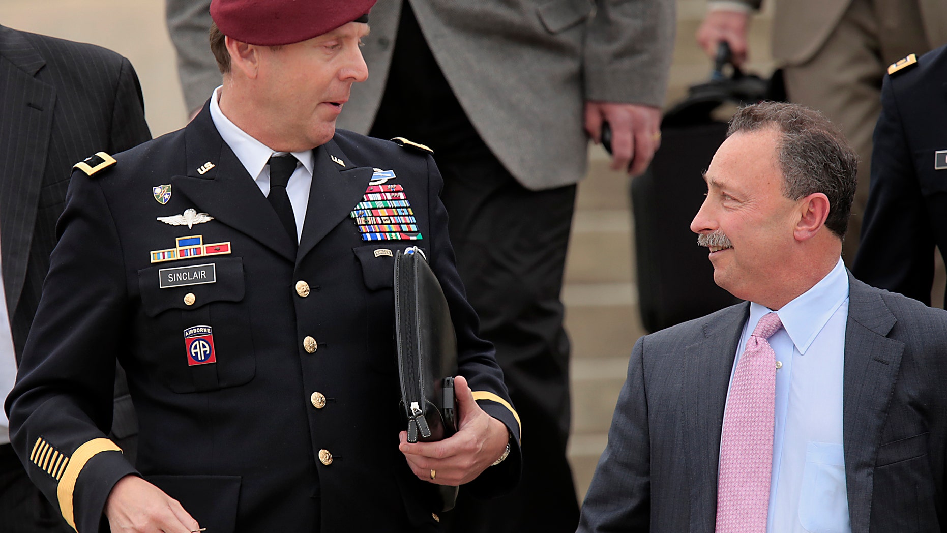 Brig. Gen. Jeffrey Sinclair, left, leaves court at Fort Bragg, N.C., Wednesday, March 19, 2014.
