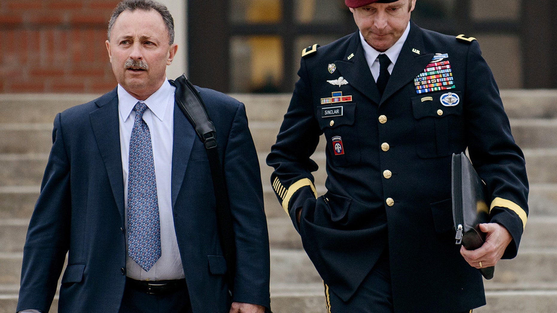 FILE - In this March 4, 2014, file photo, Brig. Gen. Jeffrey Sinclair, right, leaves the courthouse with his lawyers Richard Scheff, left, and Ellen C. Brotman, not pictured, following a day of motions at Fort Bragg, N.C. A military judge declined Monday, March 10, 2014, to dismiss sexual assault charges against Sinclair after reviewing what he said was evidence that political considerations influenced the military's handling of the case. (AP Photo/The Fayetteville Observer, James Robinson, File)