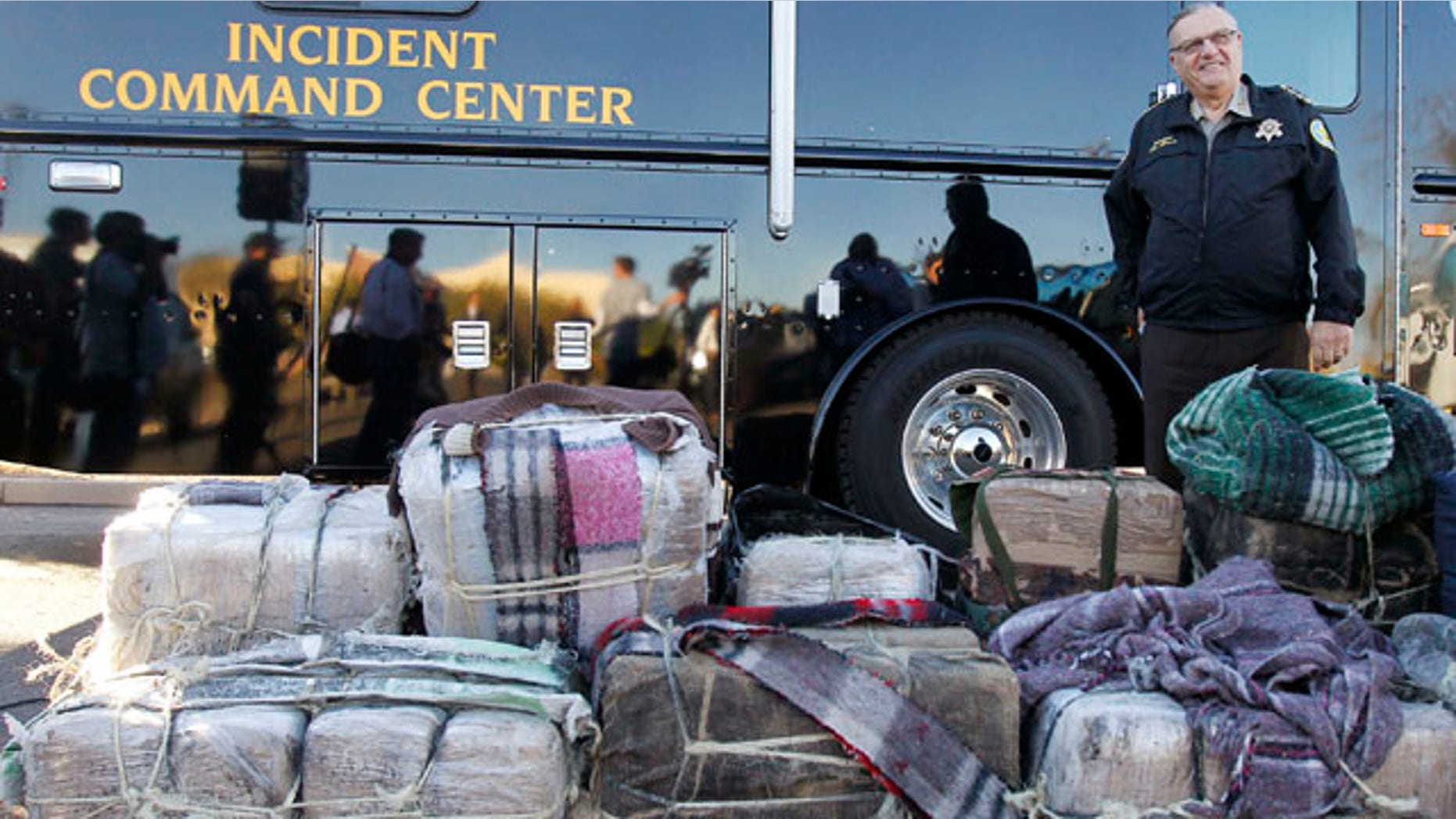Jan. 27: Maricopa County Sheriff Joe Arpaio stands in front of bales of marijuana seized by his deputies, after speaking at a news conference. There he announced his latest crime suppression illegal immigration operation sweep at the Maricopa County Sheriff's Training Academy in Phoenix.
