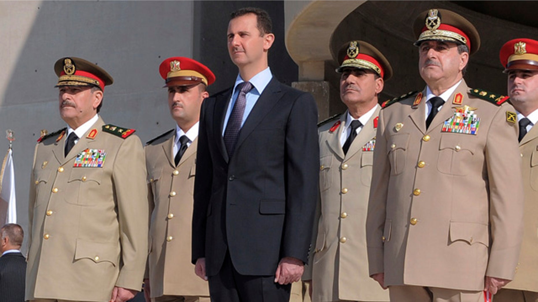 Oct. 6: Syrian President Bashar Assad, center, stands next to Syrian Defense Minister Gen. Dawoud Rajha, right, and Chief of Staff Gen. Fahed al-Jasem el-Freij, left, during a ceremony to mark the 38th anniversary of the October 1973 Arab-Israeli war, in Damascus, Syria.