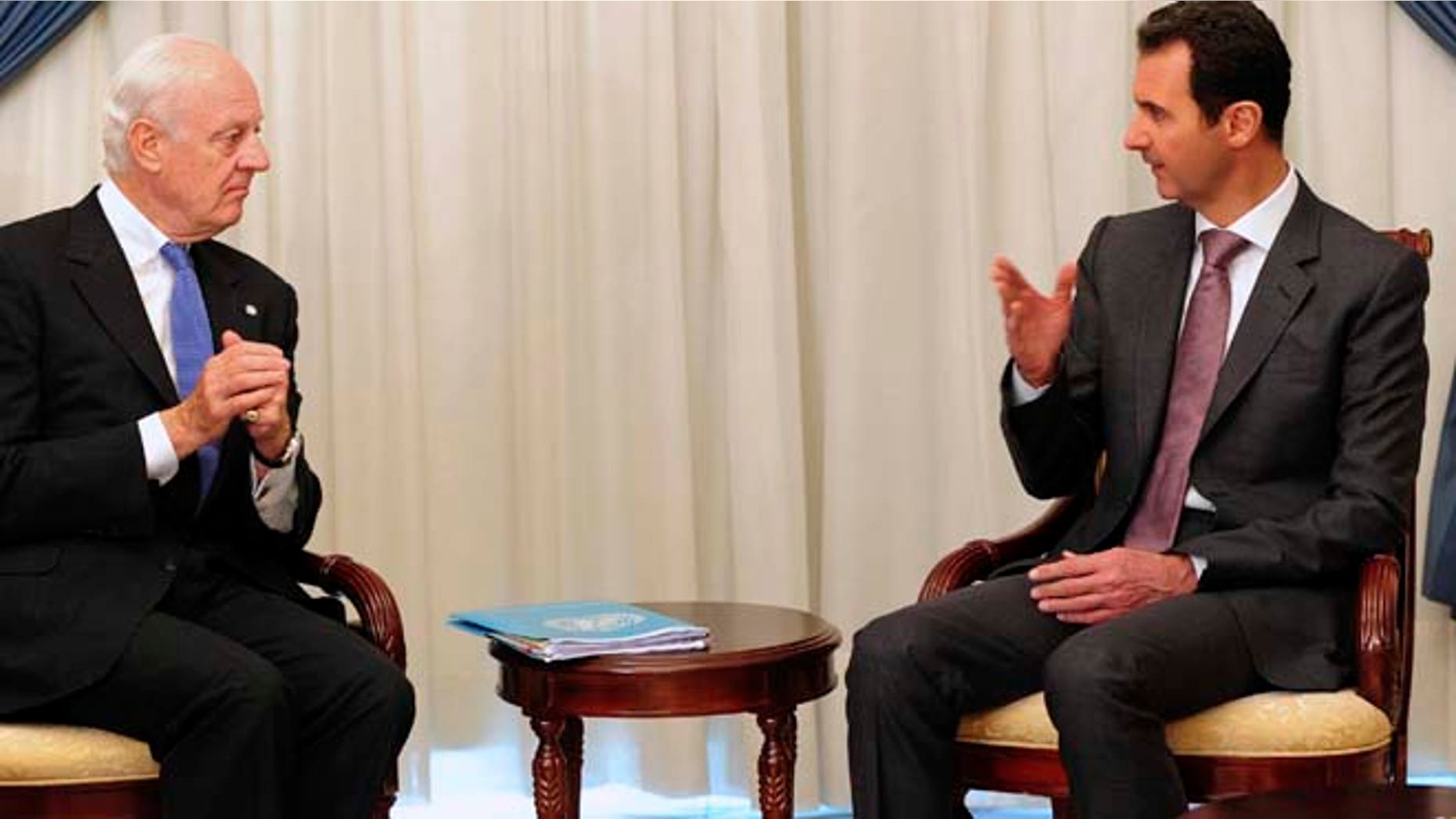 Nov. 10, 2014: In this photo released by the Syrian official news agency SANA, Syrian President Bashar Assad, right, speaks with United Nations special envoy to Syria Staffan de Mistura in Damascus, Syria. (AP/SANA)
