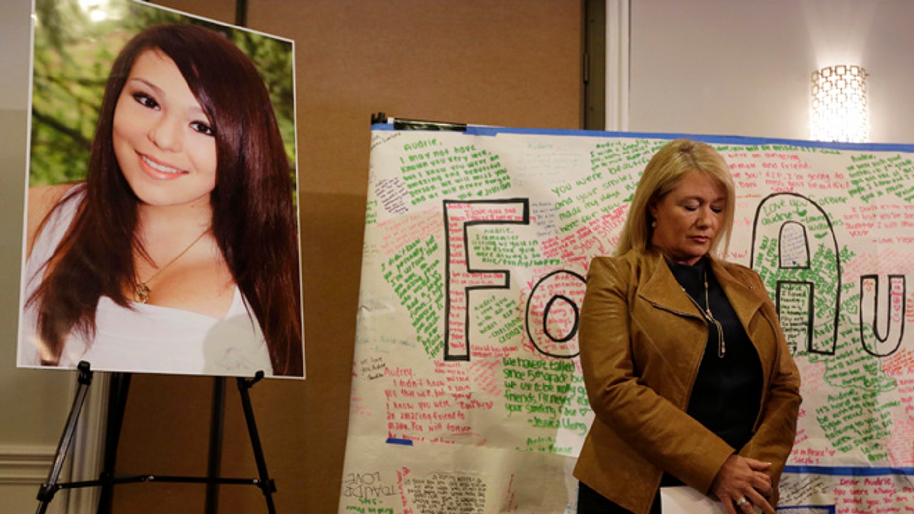 April 15: Sheila Pott, mother of Audrie Pott, stands by a photograph of her daughter and message board during a news conference in San Jose, Calif.