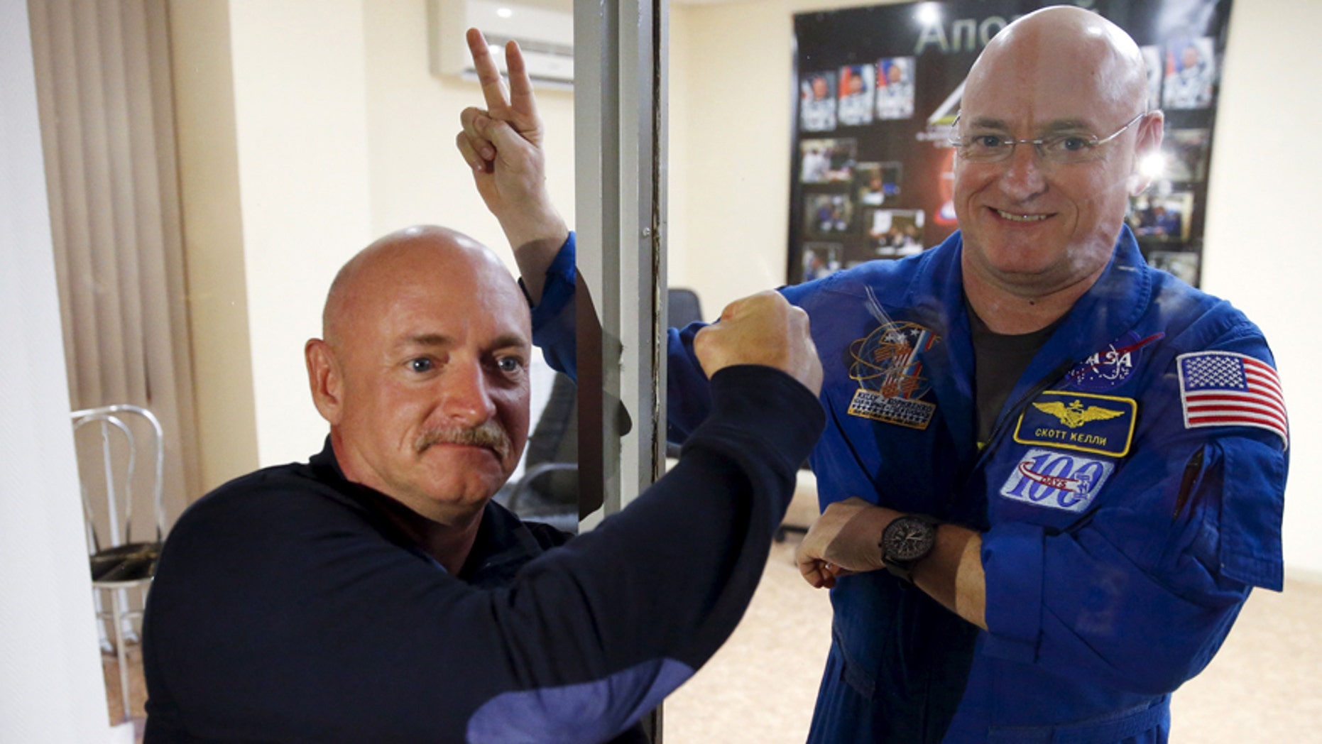 NASA astronaut Scott Kelly (R), member of the 43 International Space Station crew, and his twin brother Mark pose after a news conference at Baikonur cosmodrome March 26, 2015.