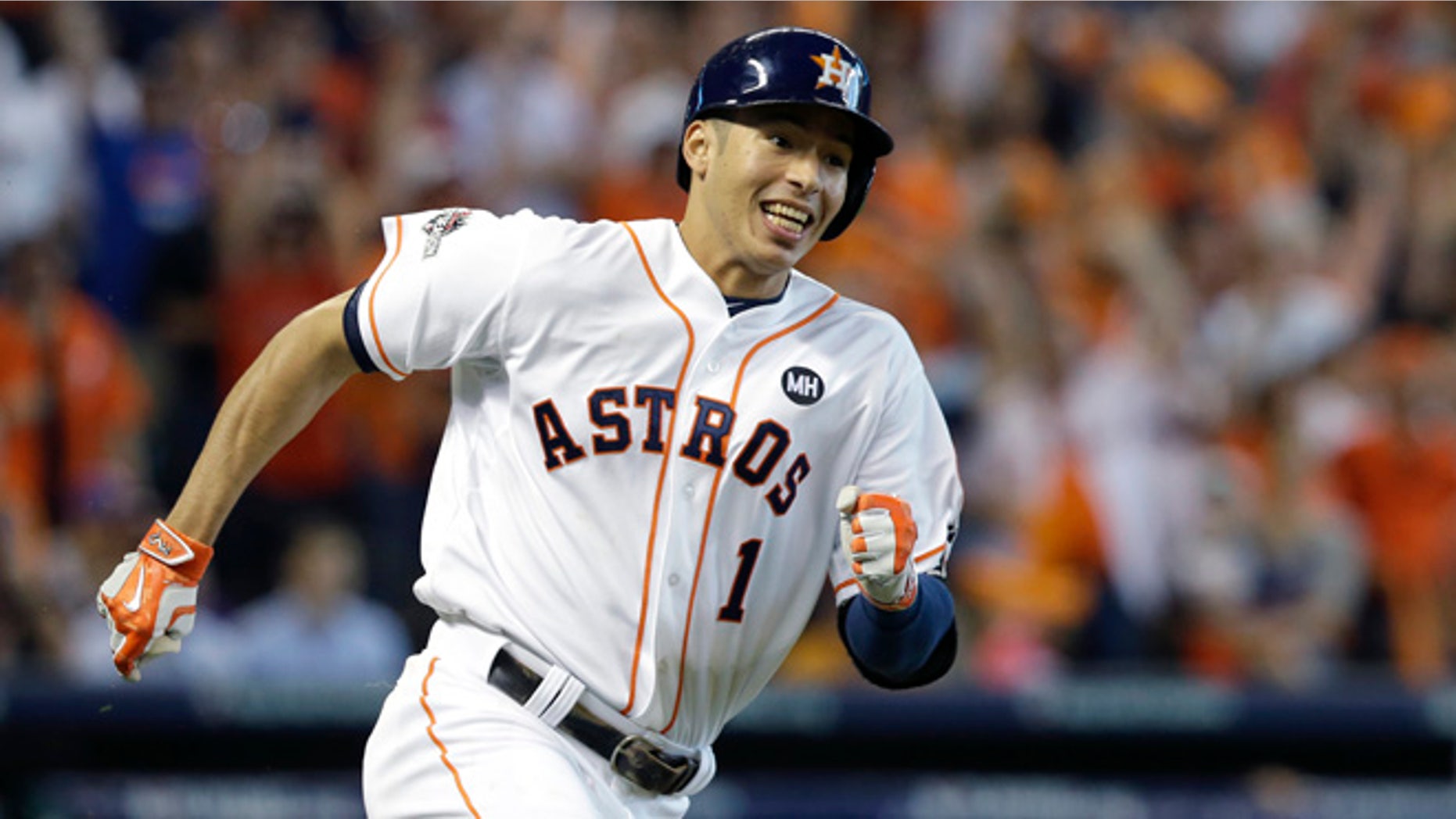 FILE - In this Oct. 12, 2015, file photo, Houston Astros' Carlos Correa races to first base after an RBI hitting a single against the Kansas City Royals during Game 4 of baseball's American League Division Series in Houston. Last year's AL Rookie of Year has a closet filled with hundreds of pairs of shoes and is constantly adding to the collection. The shoes symbolize just how far Houston's shortstop has come from a childhood in Puerto Rico where he recalls having only one pair for more than two years. (AP Photo/Pat Sullivan, File)