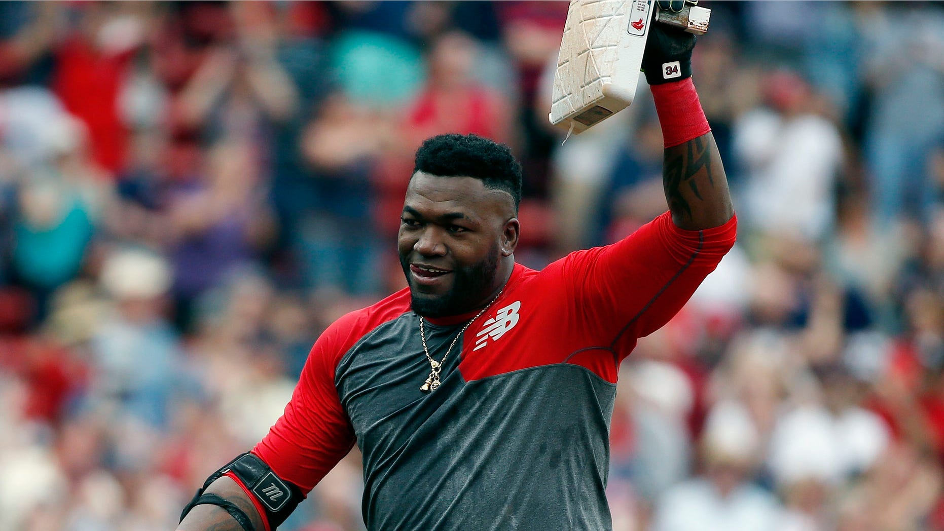 Boston Red Sox's David Ortiz holds up second base after hitting the game-winning RBI double during the 11th inning of a baseball game against the Houston Astros in Boston, Saturday, May 14, 2016. The Red Sox won 6-5. (AP Photo/Michael Dwyer)