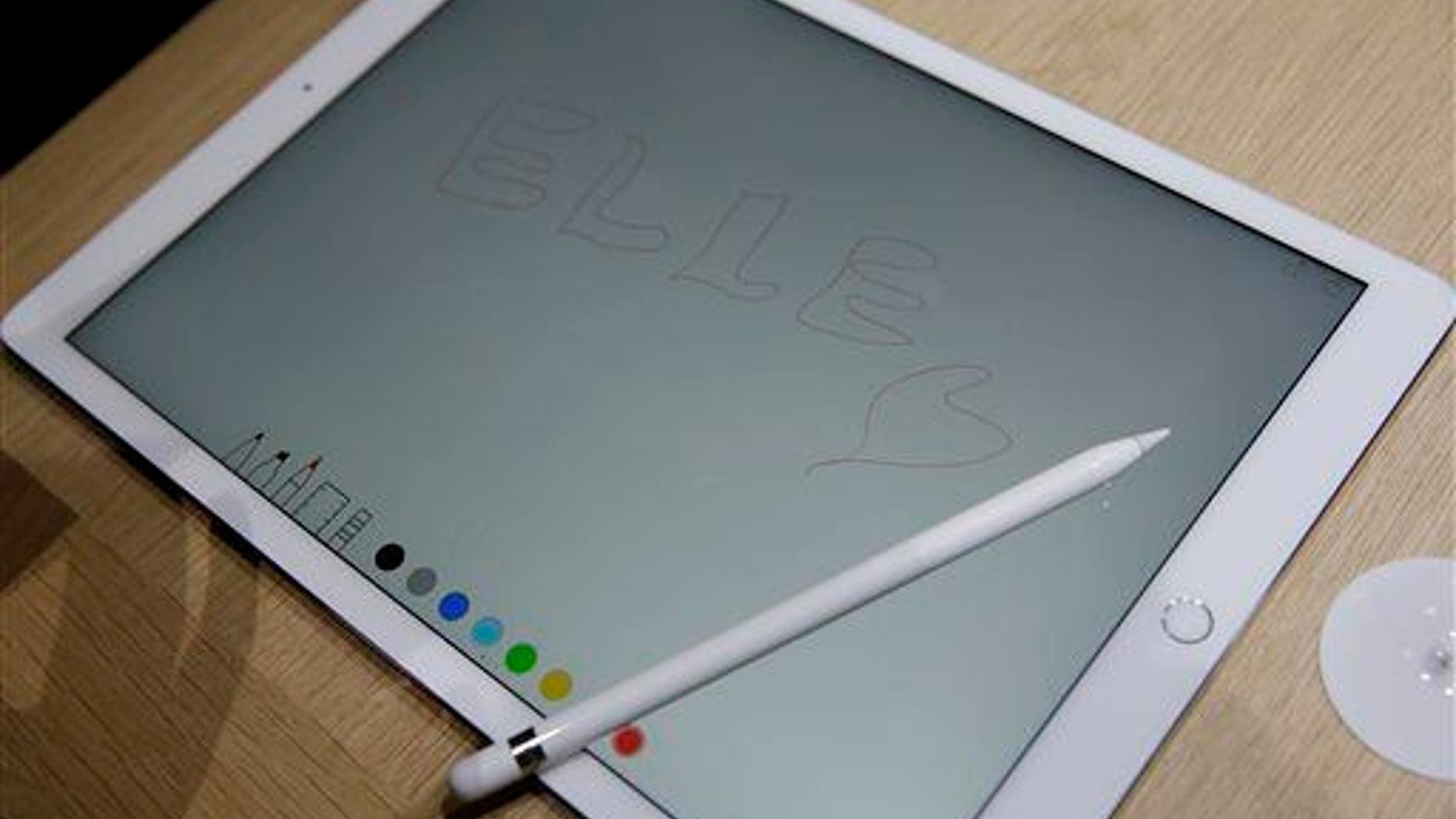 The new Apple Pencil rests on top of the iPad Pro.