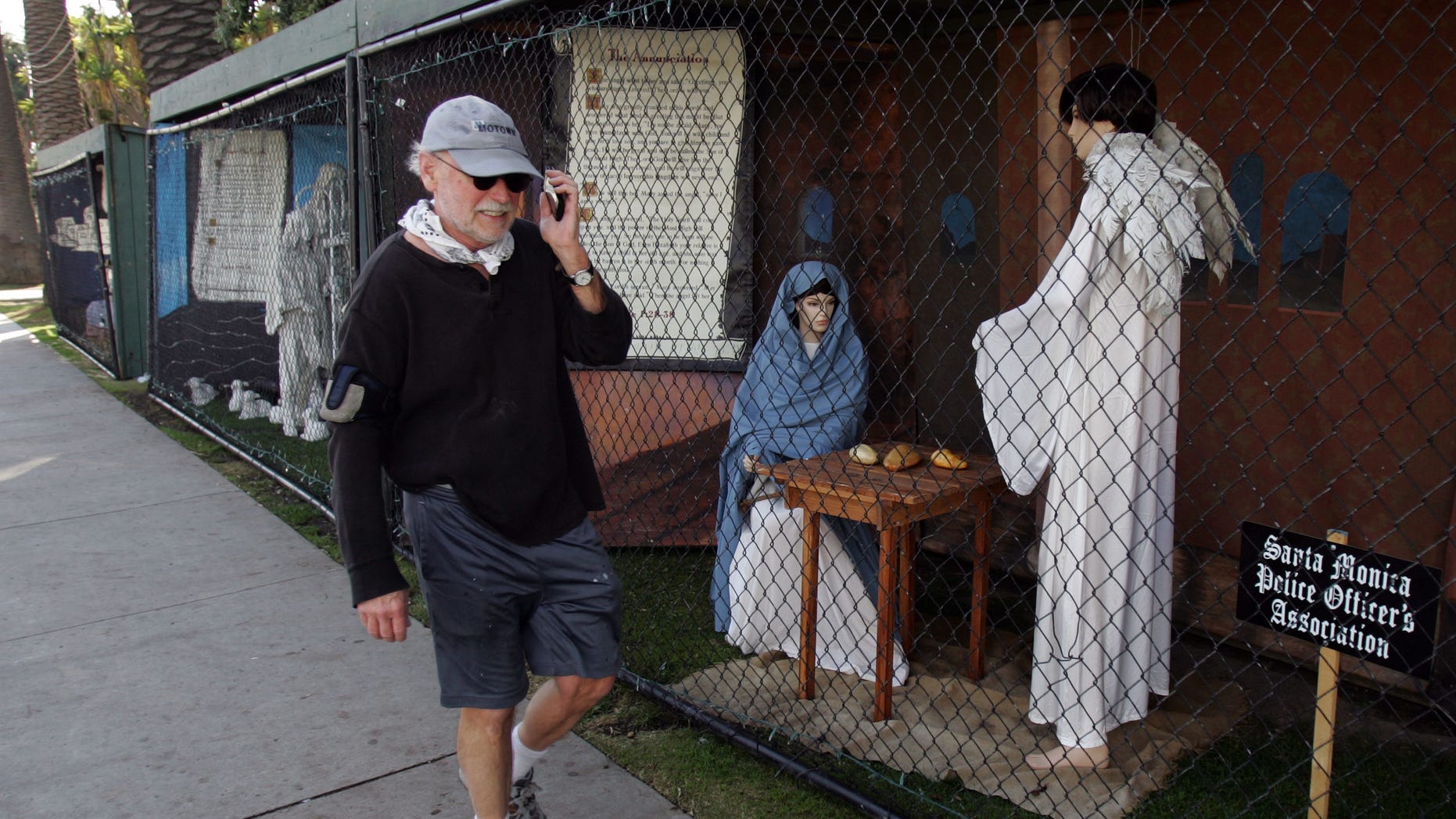 December 13: A man walks past a display showing the nativity scene along Ocean Avenue at Palisades Park in Santa Monica, California.
