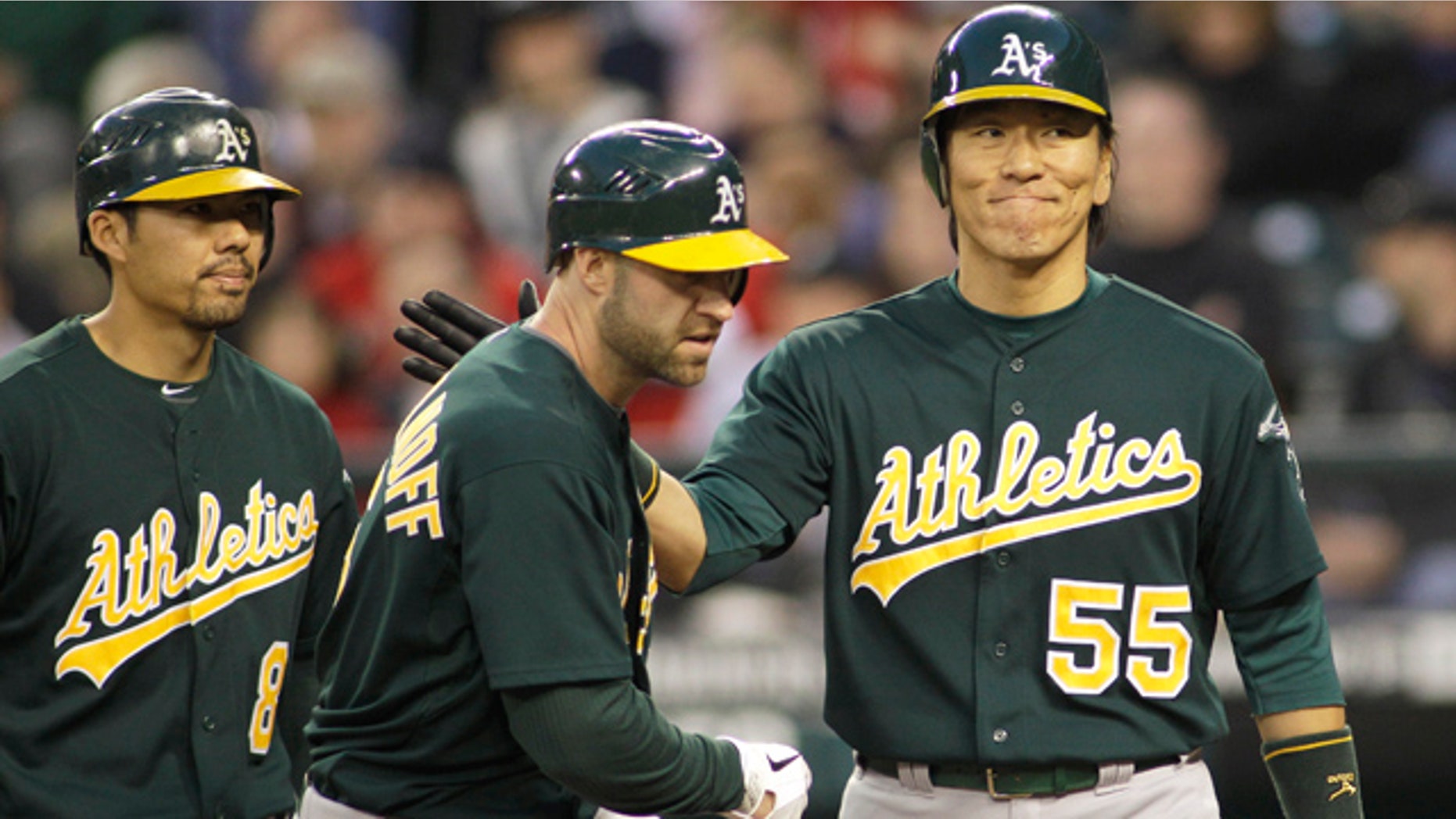 April 23, 2011: Oakland Athletics' Kevin Kouzmanoff, center, is greeted by Hideki Matsui, right, after Matsui and Kurt Suzuki, left, scored when Kouzmanoff hit a three-run home run against the Seattle Mariners in the sixth inning of a baseball game.