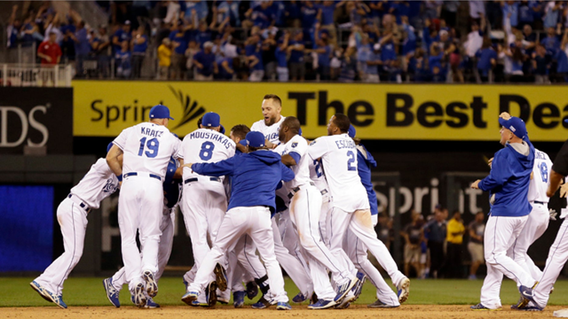 September 30, 2014: Kansas City Royals mob teammate Salvador Perez after he hit a walk-off single in the 12th inning to defeat the Oakland Athletics 9-8 in the AL wild-card playoff baseball game in Kansas City, Mo. (AP Photo/Jeff Roberson)