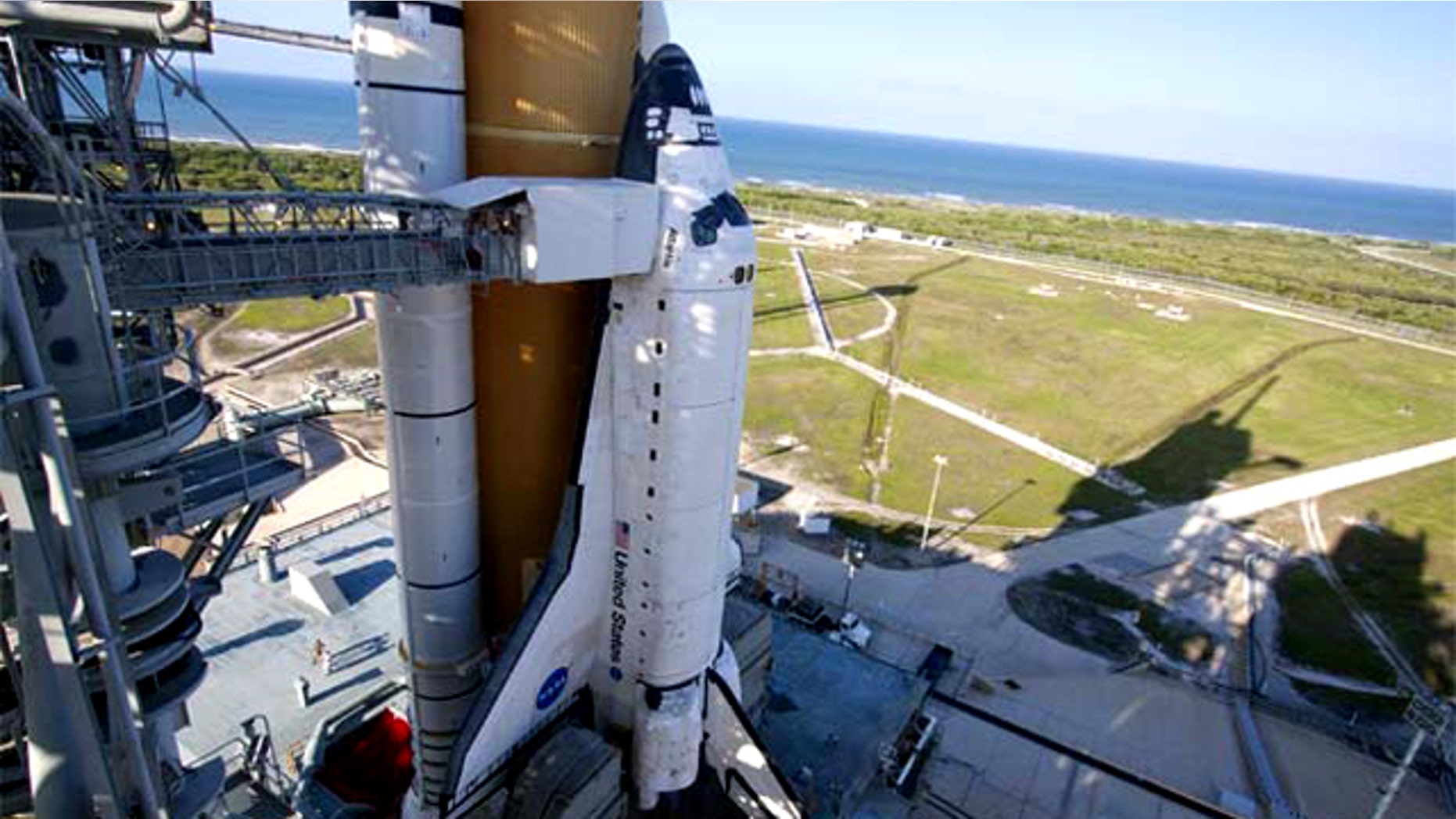 At NASA Kennedy Space Center's Launch Pad 39A, space shuttle Atlantis is revealed Thursday evening after retraction of the pad's rotating service structure. The shuttle is scheduled to lift off Friday at 2:20 p.m. EDT.